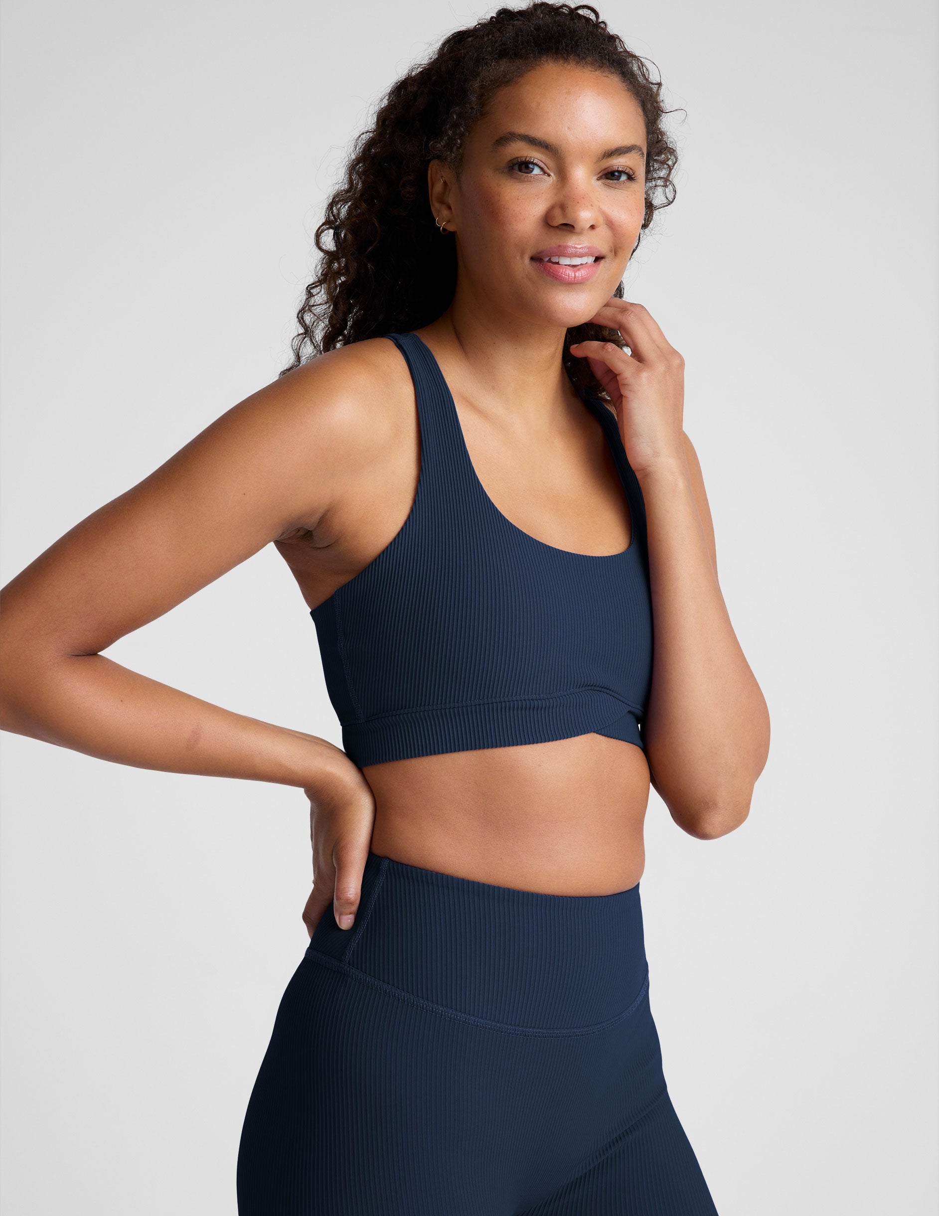 blue racerback bra with a scoop neckline
and overlapping hemband detail.