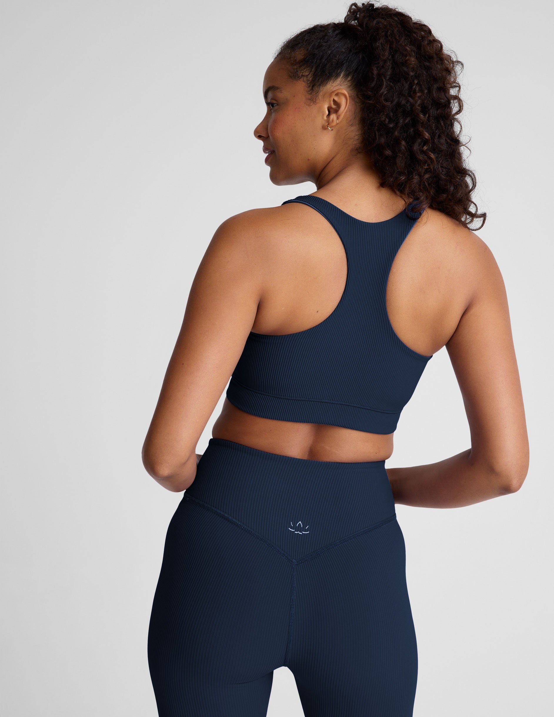 blue racerback bra with a scoop neckline
and overlapping hemband detail.