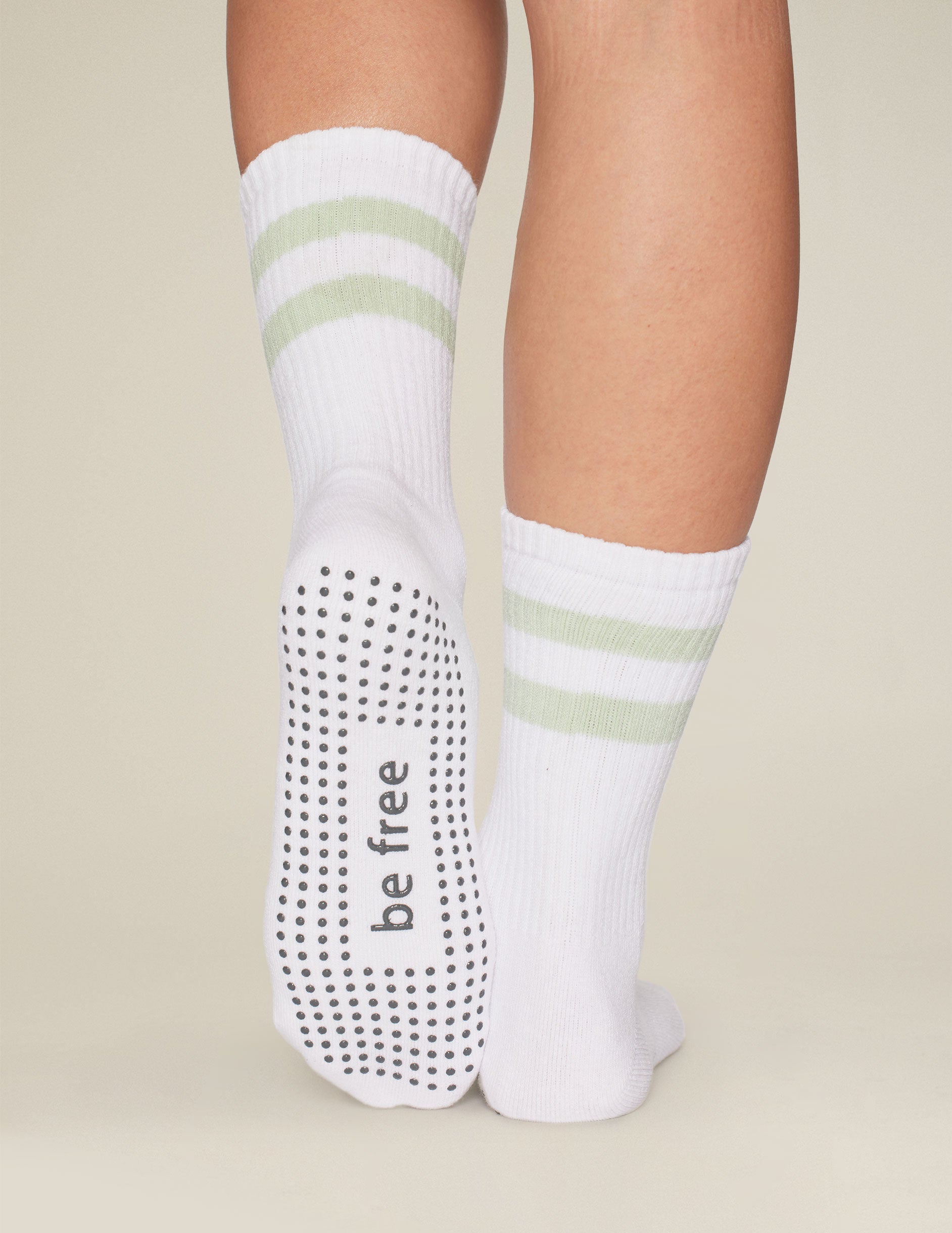 white crew length socks with green stripe detailing. 