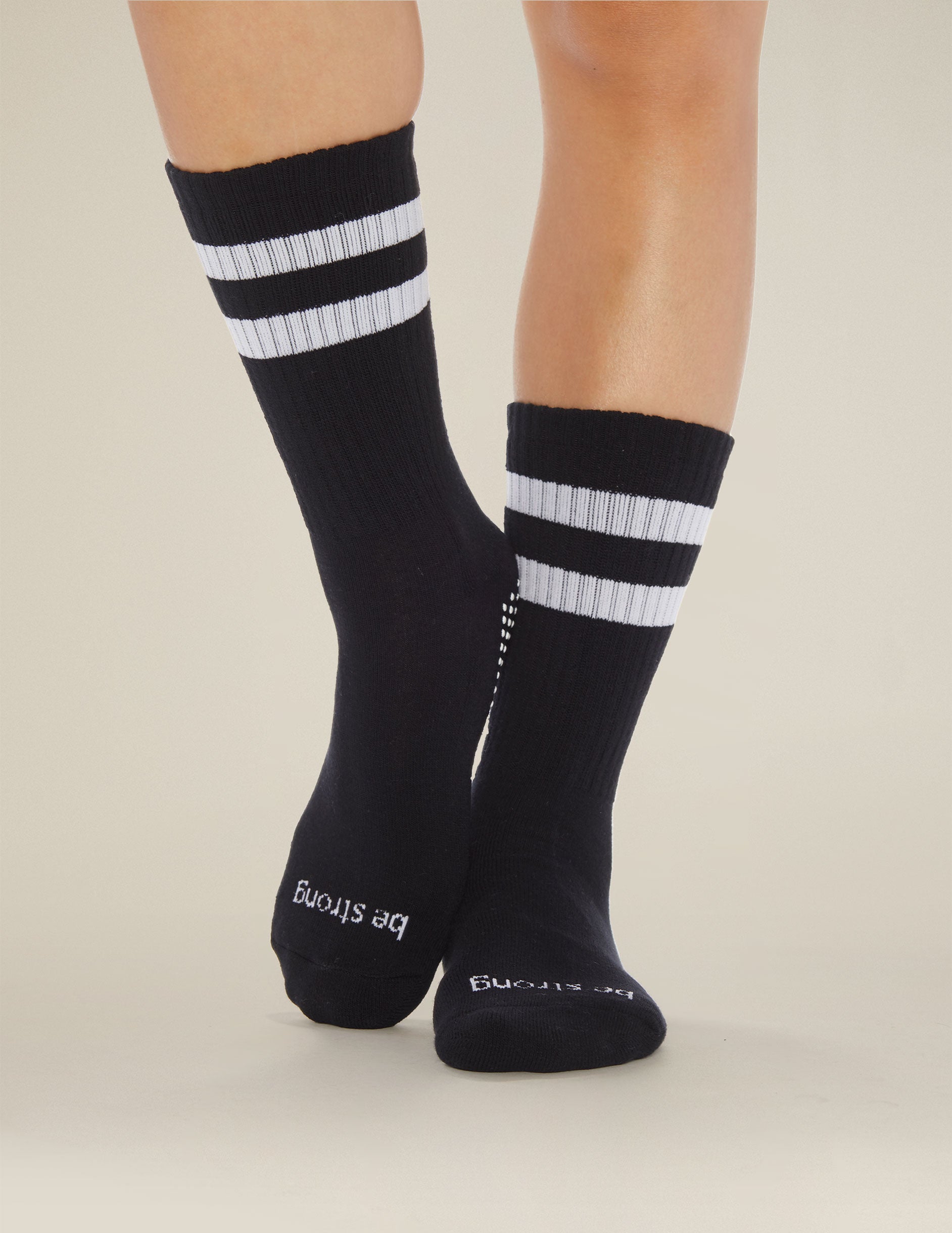 black crew length socks with white stripe detailing. 