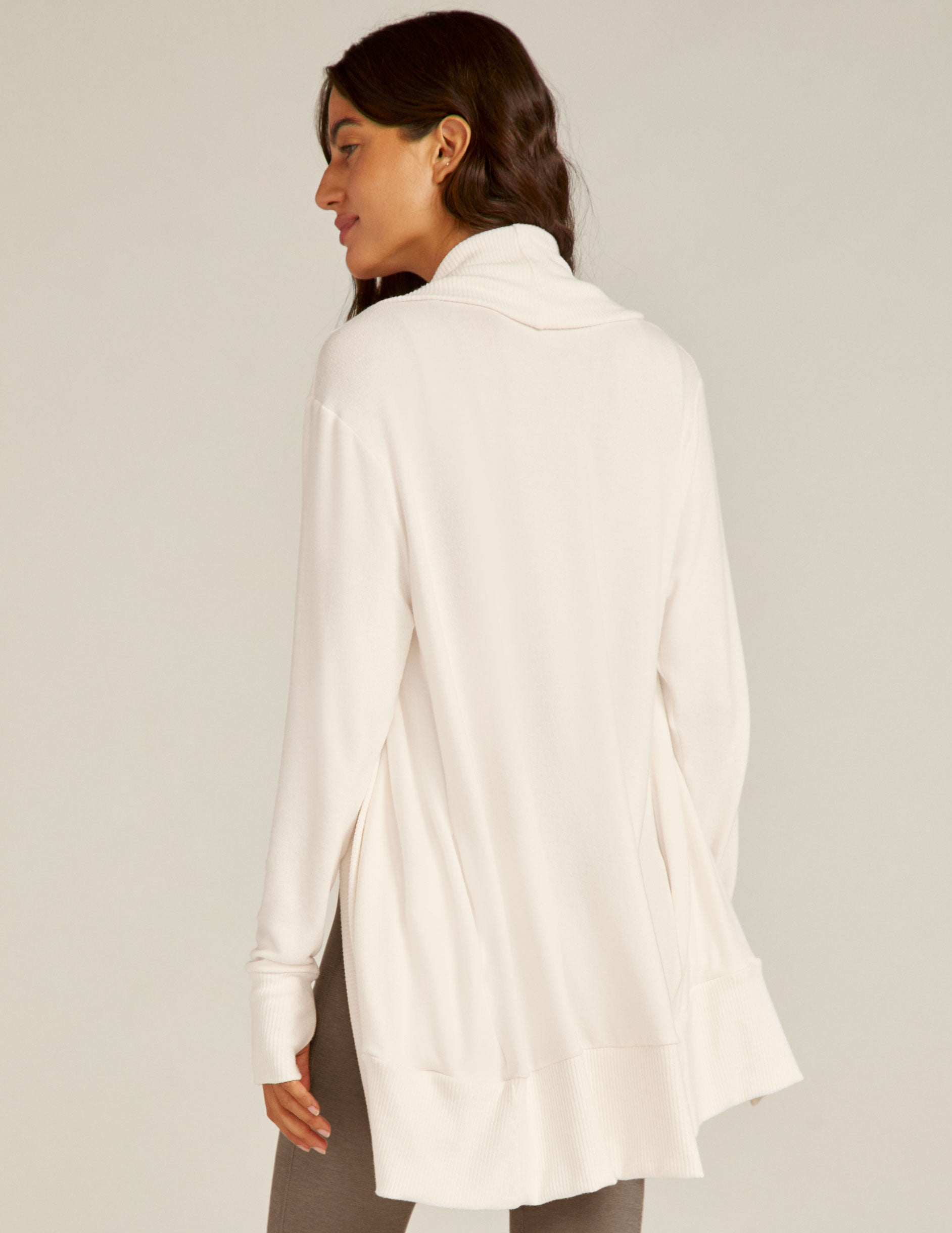 white cardigan with thumb holes.