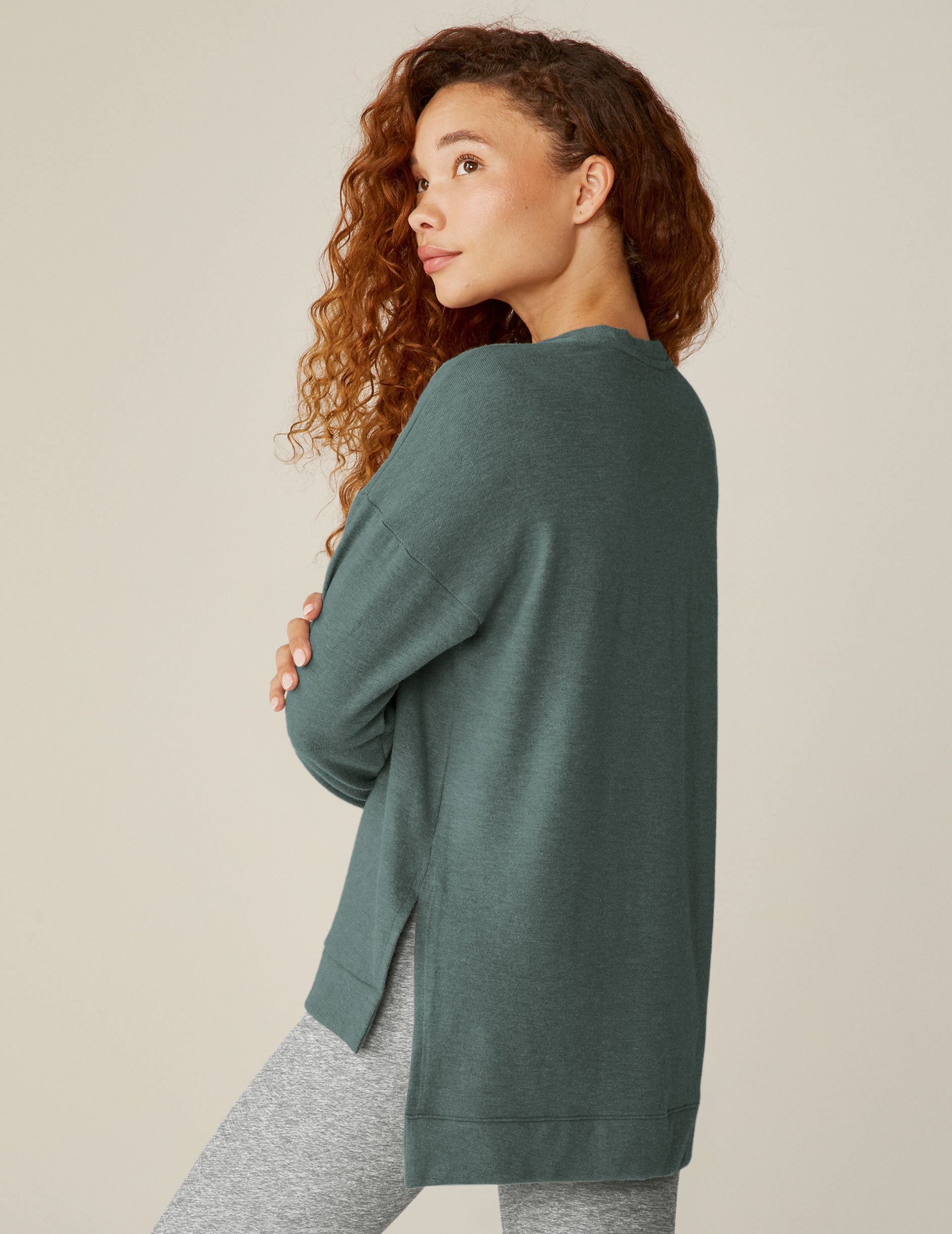 blue v-neck pullover sweater with a high-low detail at waistband and side slits. 