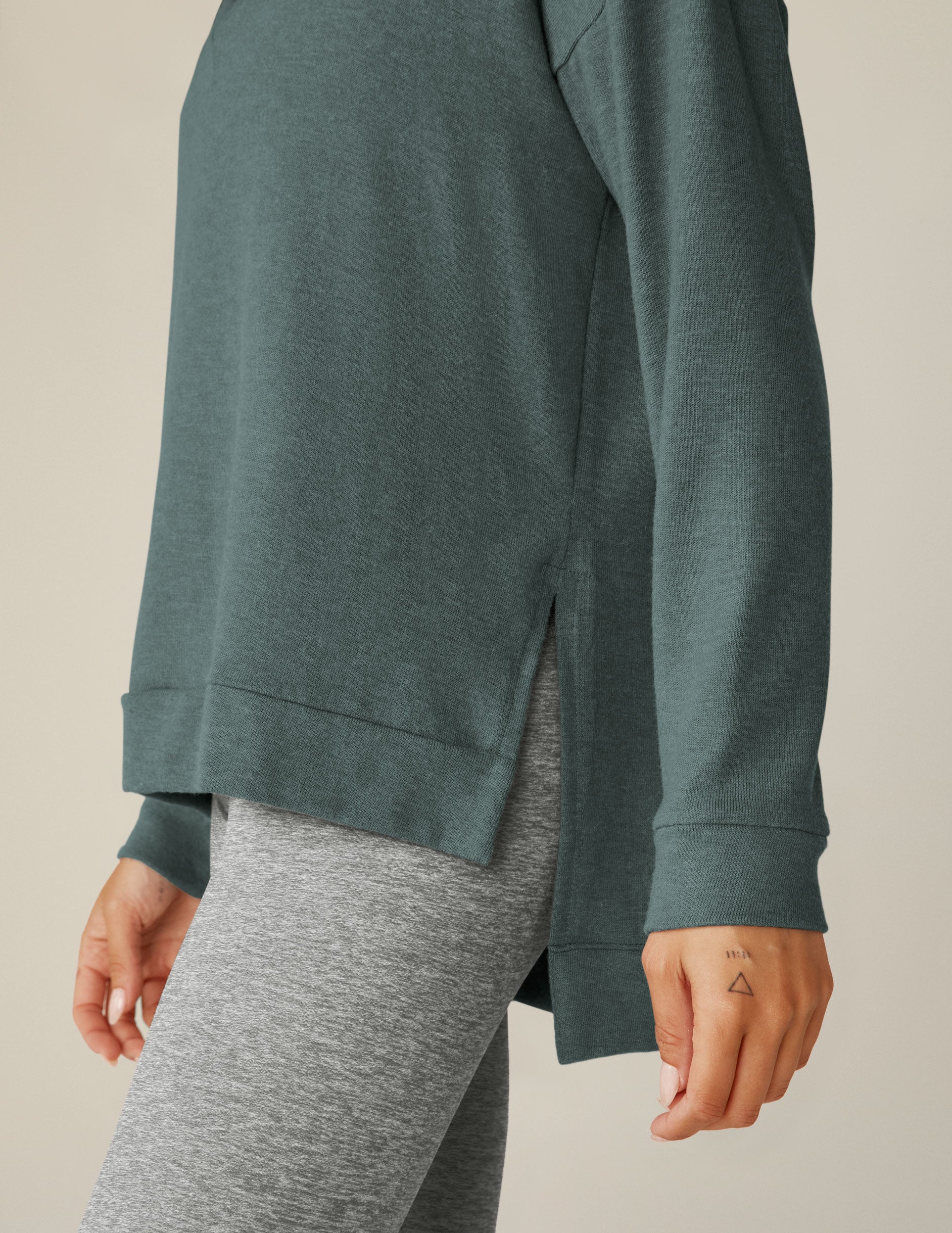 blue v-neck pullover sweater with a high-low detail at waistband and side slits. 