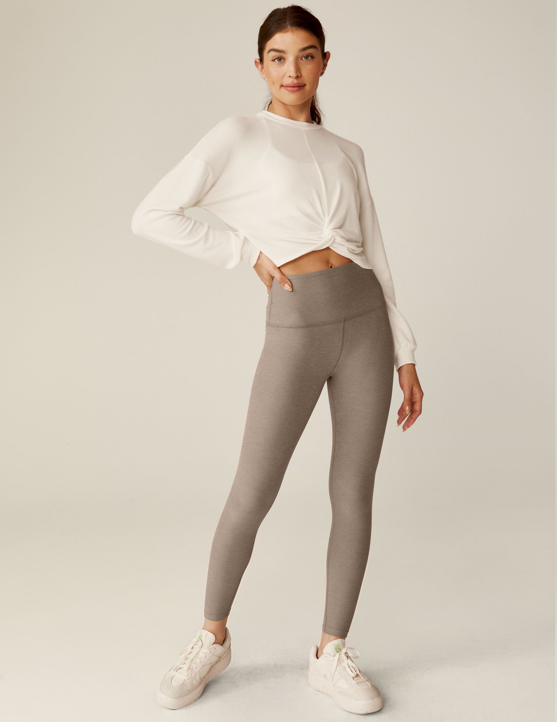 white crew neck relaxed fit cropped pullover with a detailing twist at front waist. 