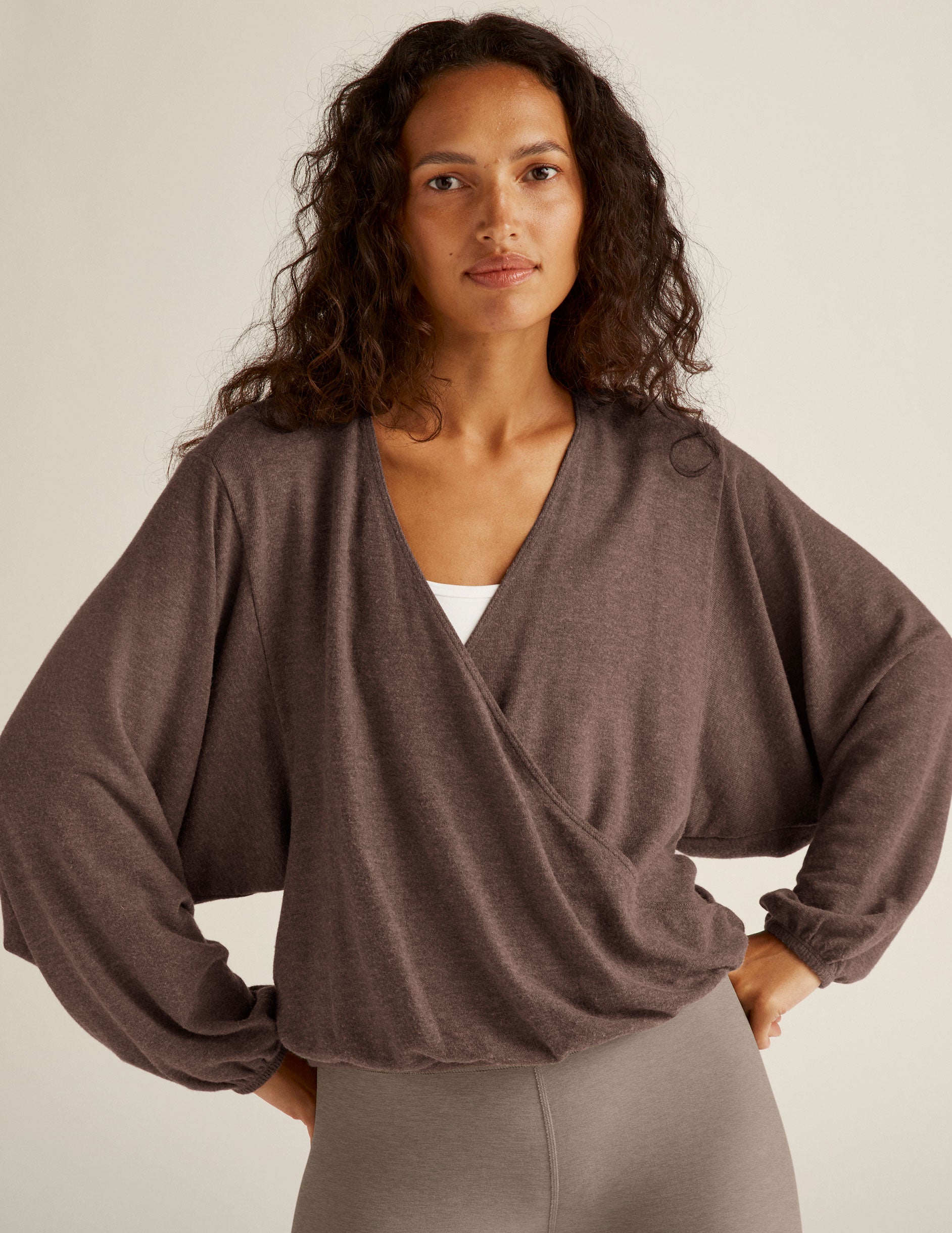 brown long sleeve pullover with a crossover design in front. 