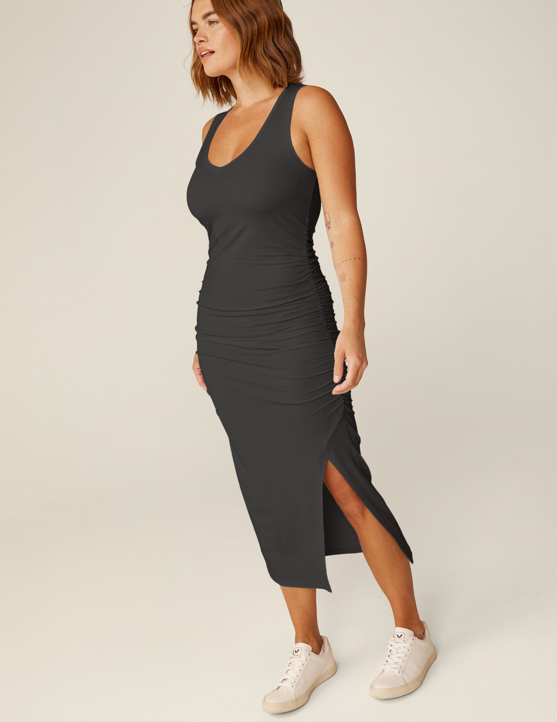 black v-neck midi dress with a front side slit and wide straps.