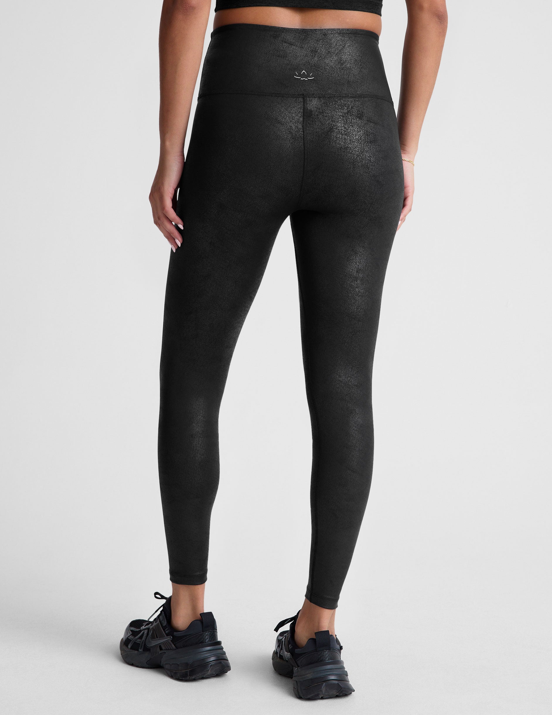 black leather high-waisted midi leggings.