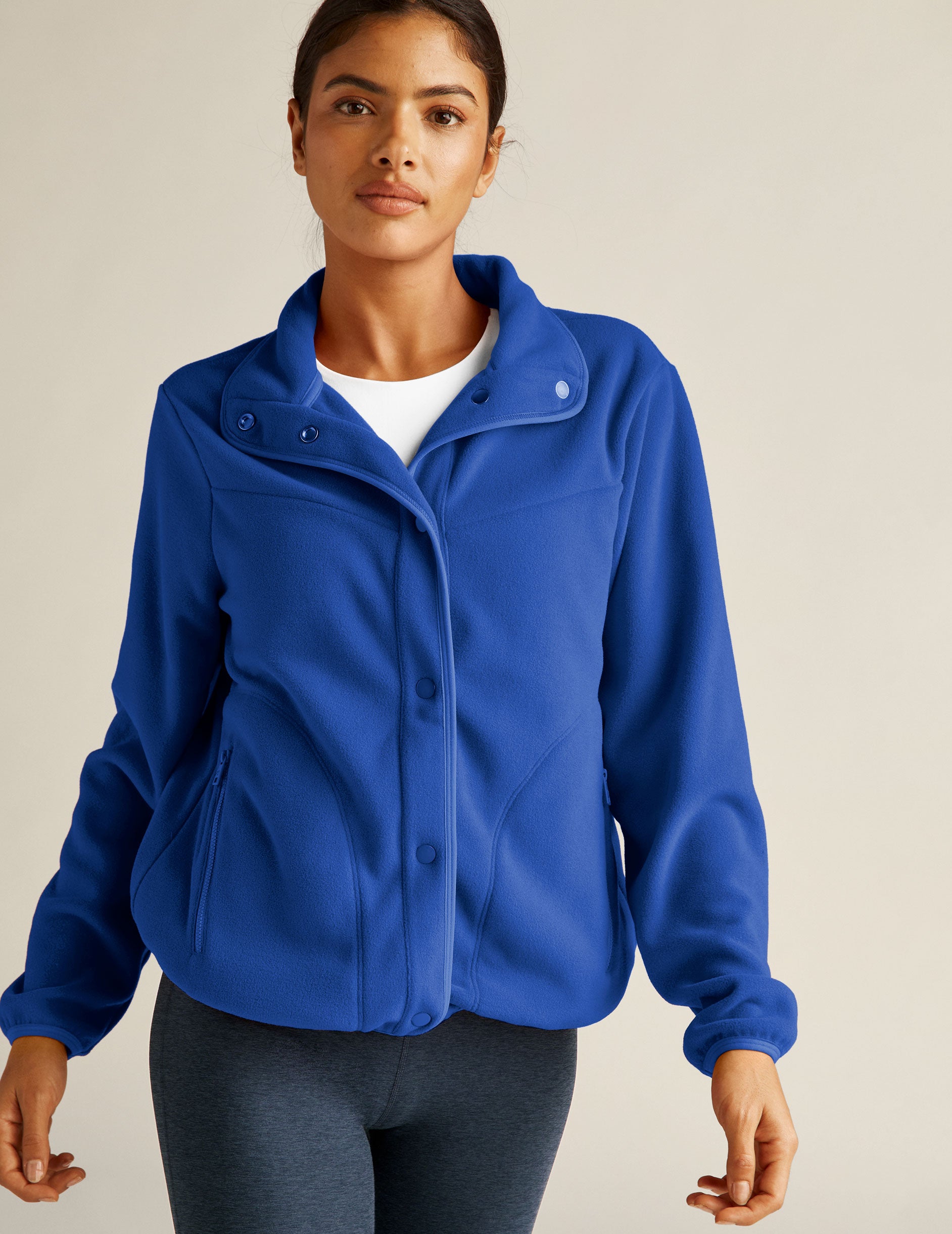 blue fleece button up jacket with zipper pockets. 