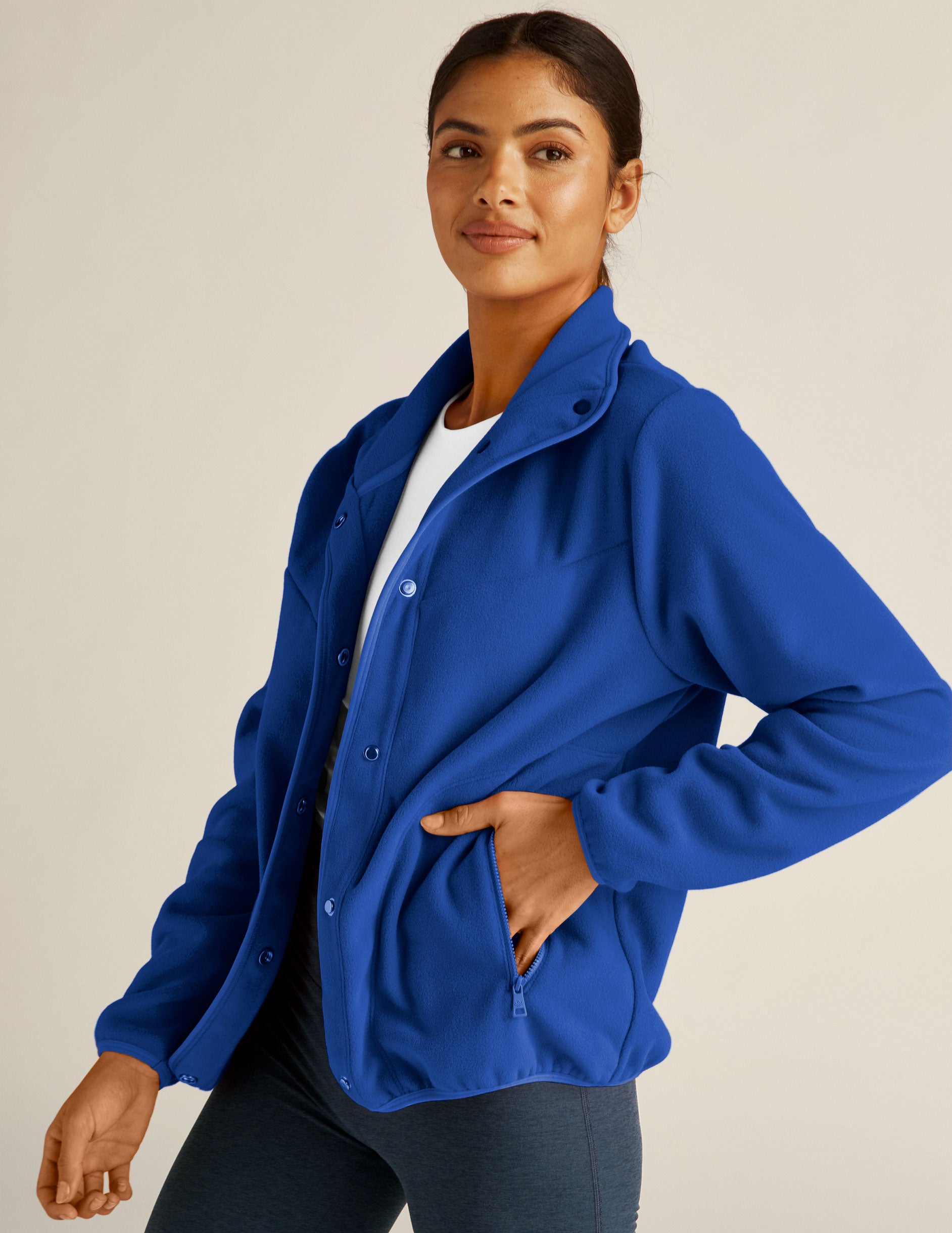 blue fleece button up jacket with zipper pockets. 