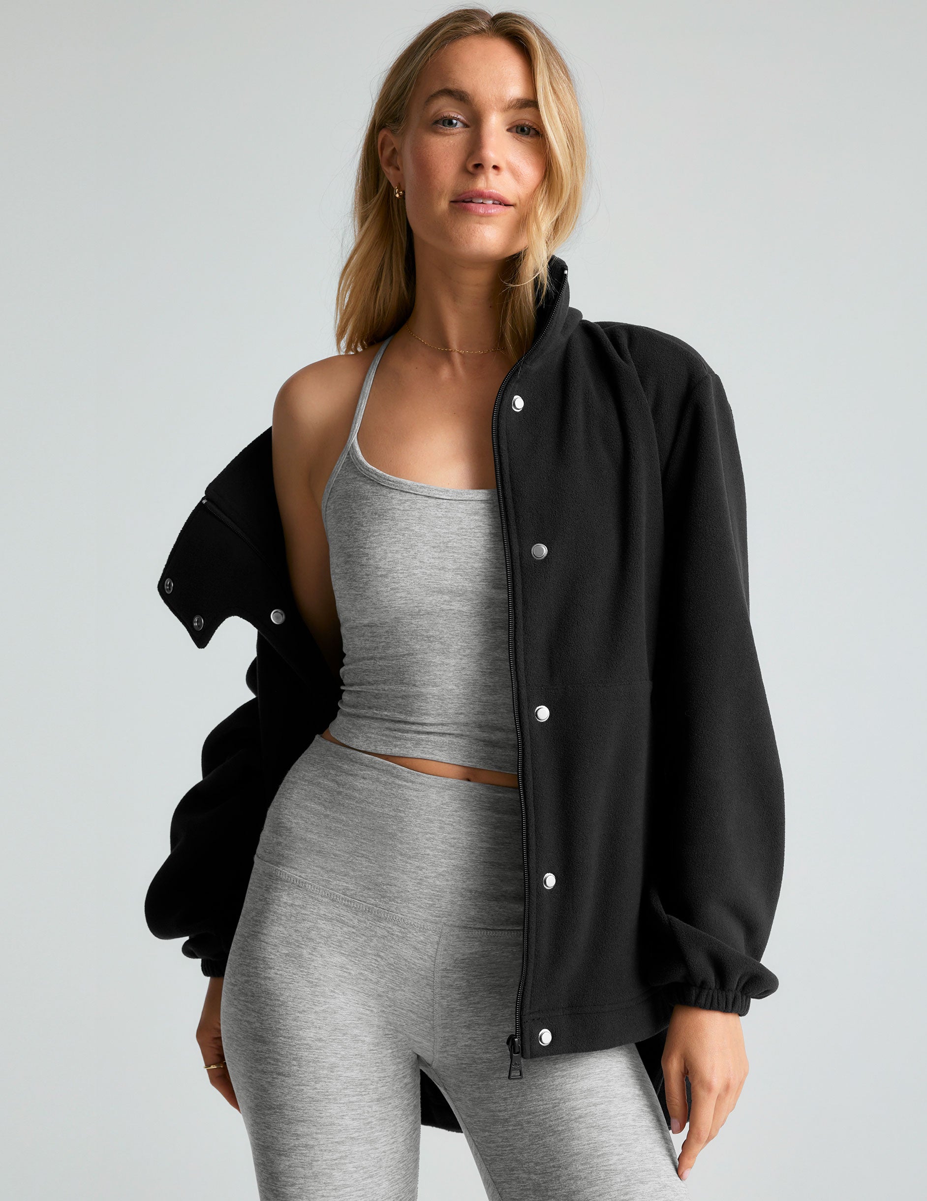 black fleece button-up jacket with side pockets.