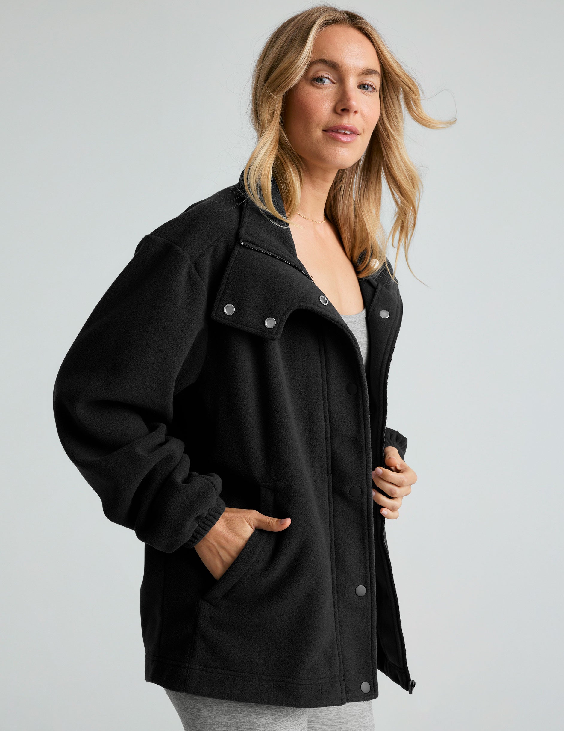 black fleece button-up jacket with side pockets.