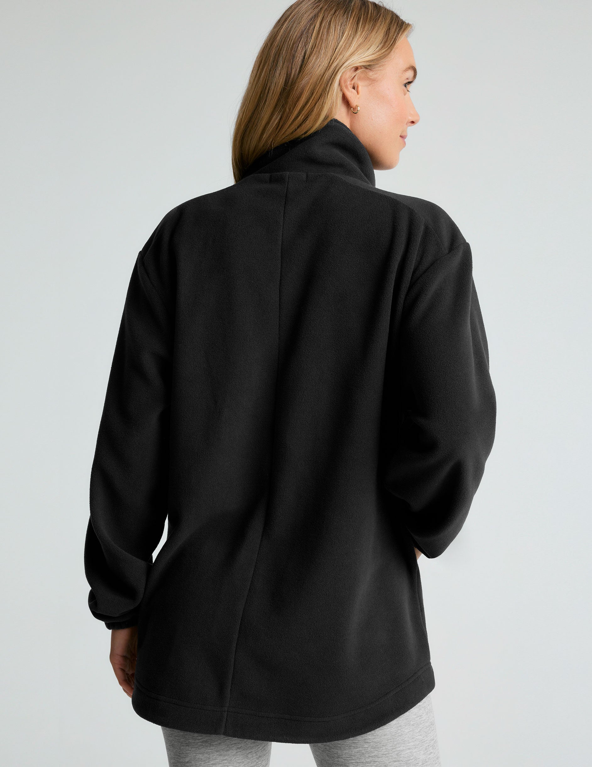black fleece button-up jacket with side pockets.