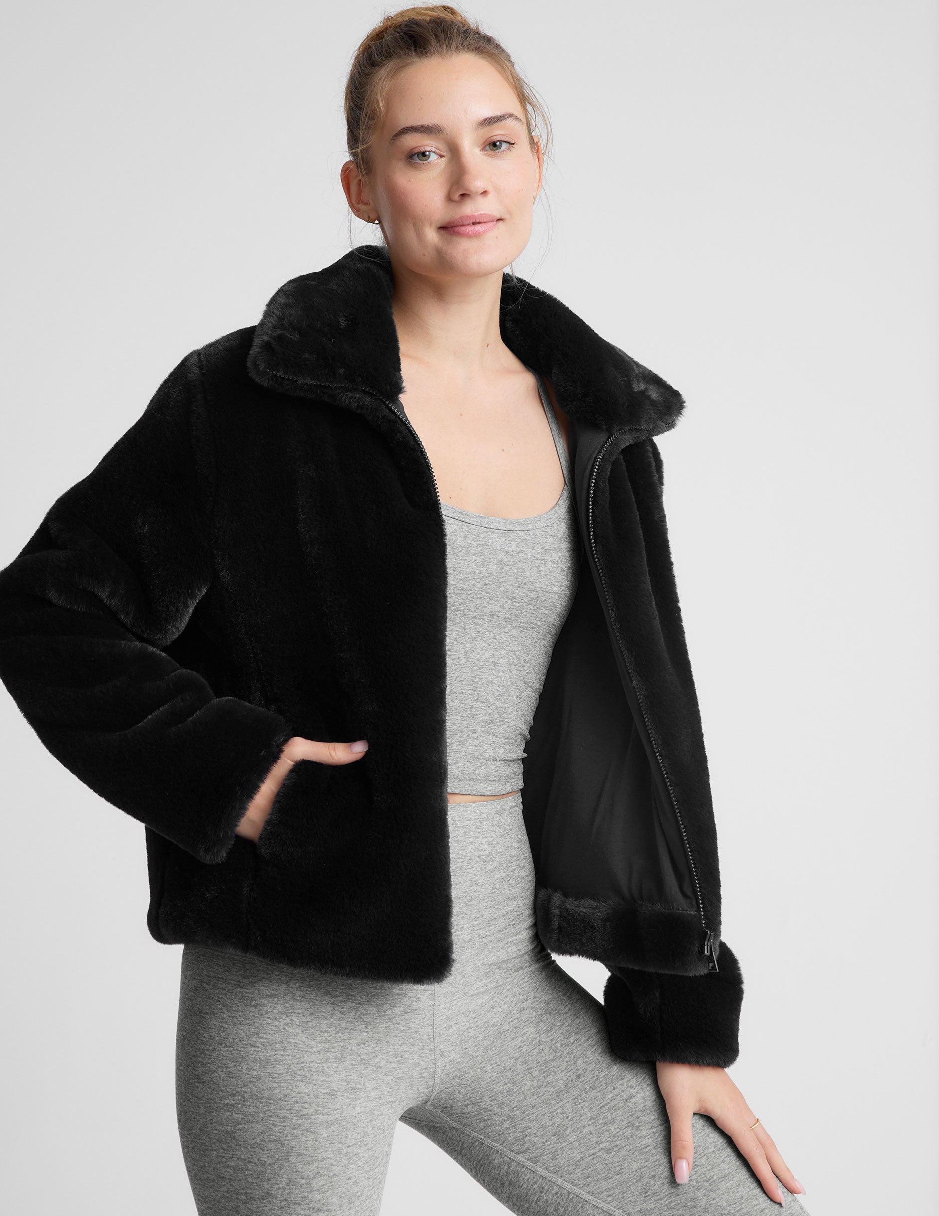 black faux fur zip-up collared jacket.