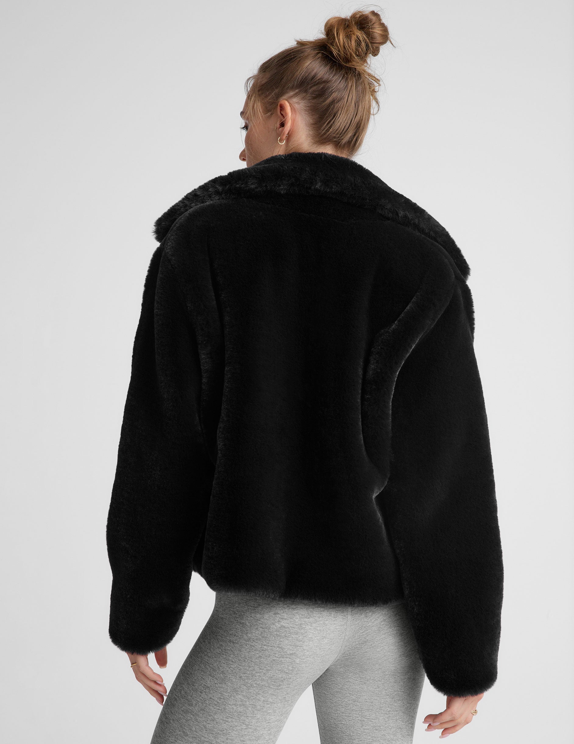 black faux fur zip-up collared jacket.