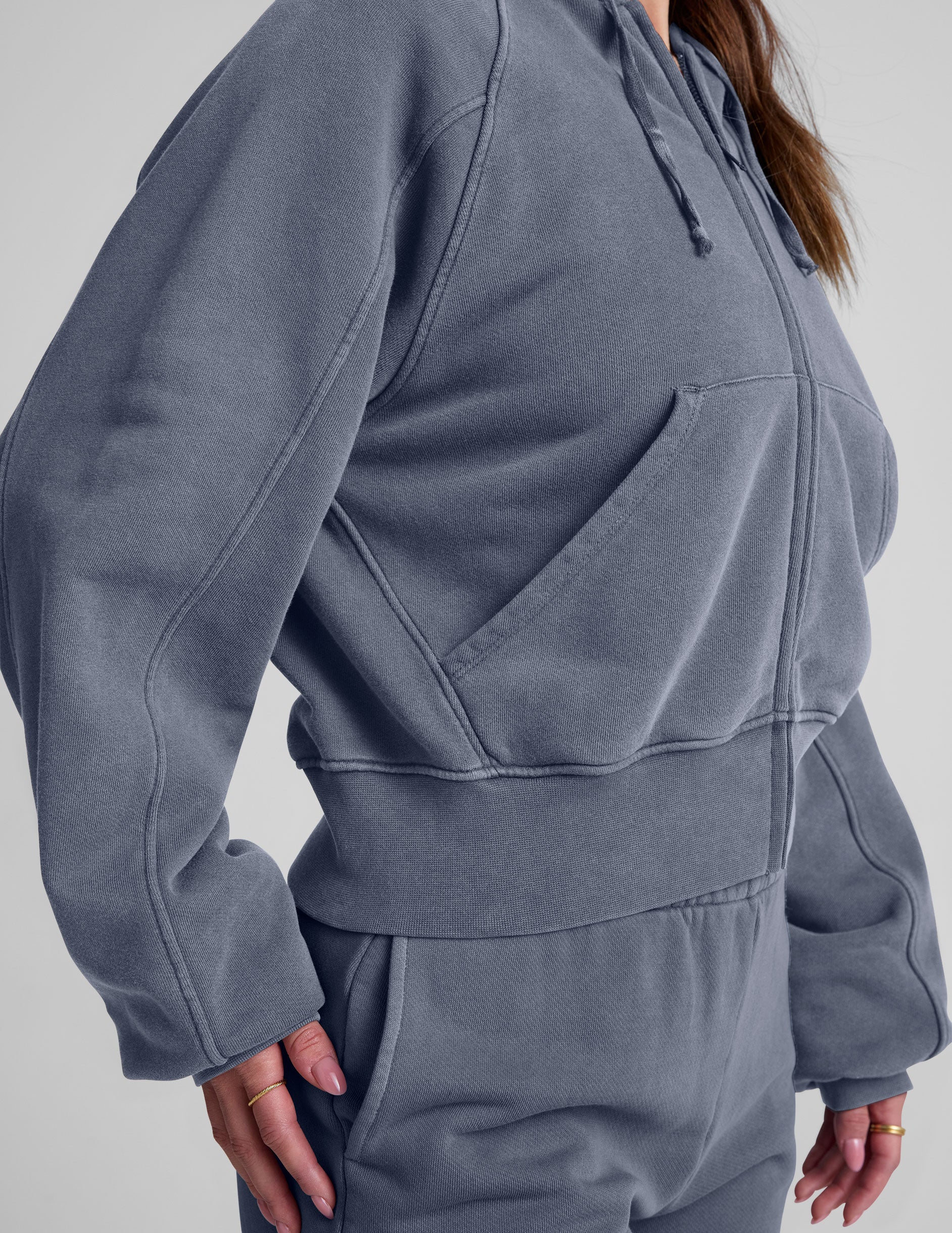 blue zip-up jacket with pockets and a hoodie.