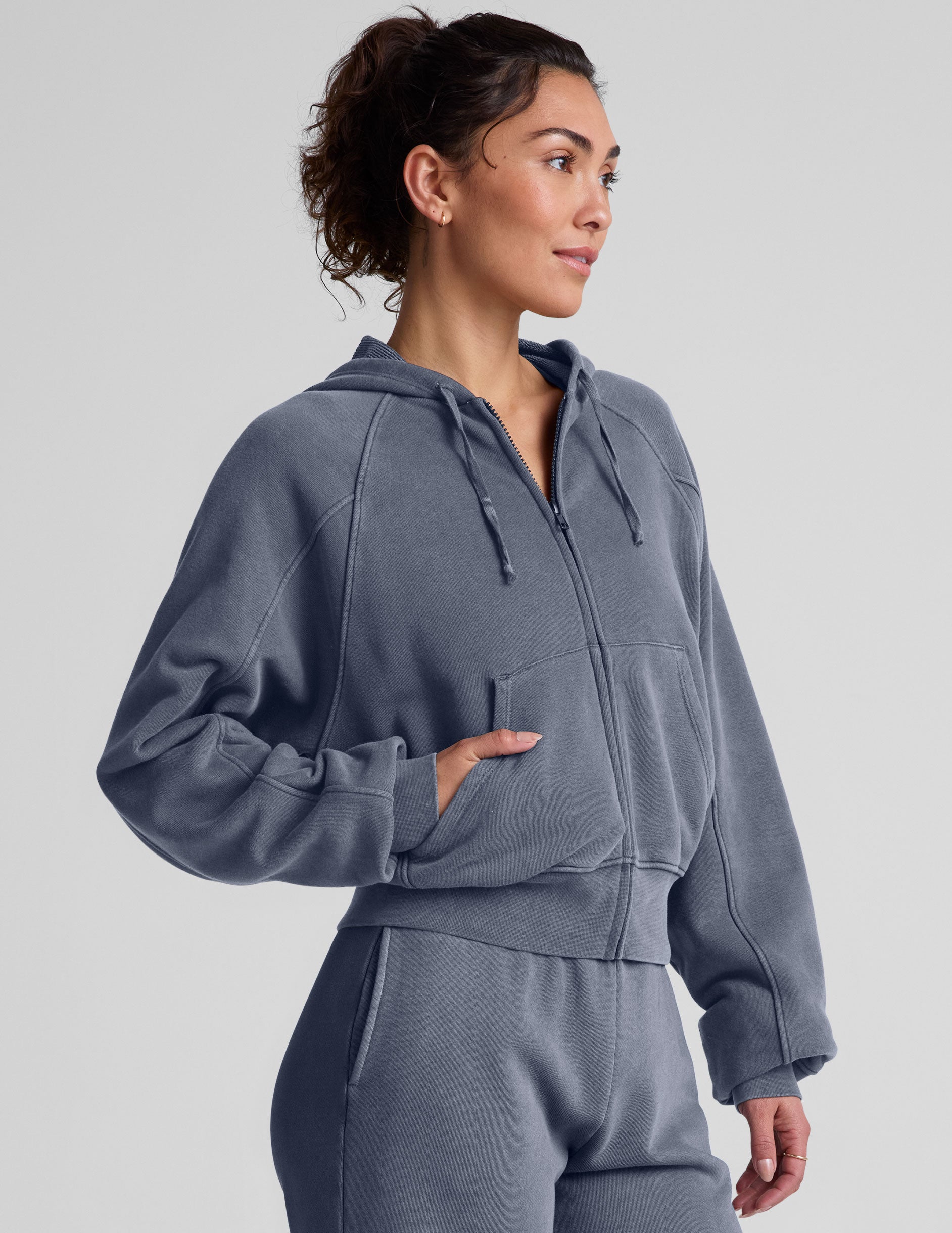 blue zip-up jacket with pockets and a hoodie.