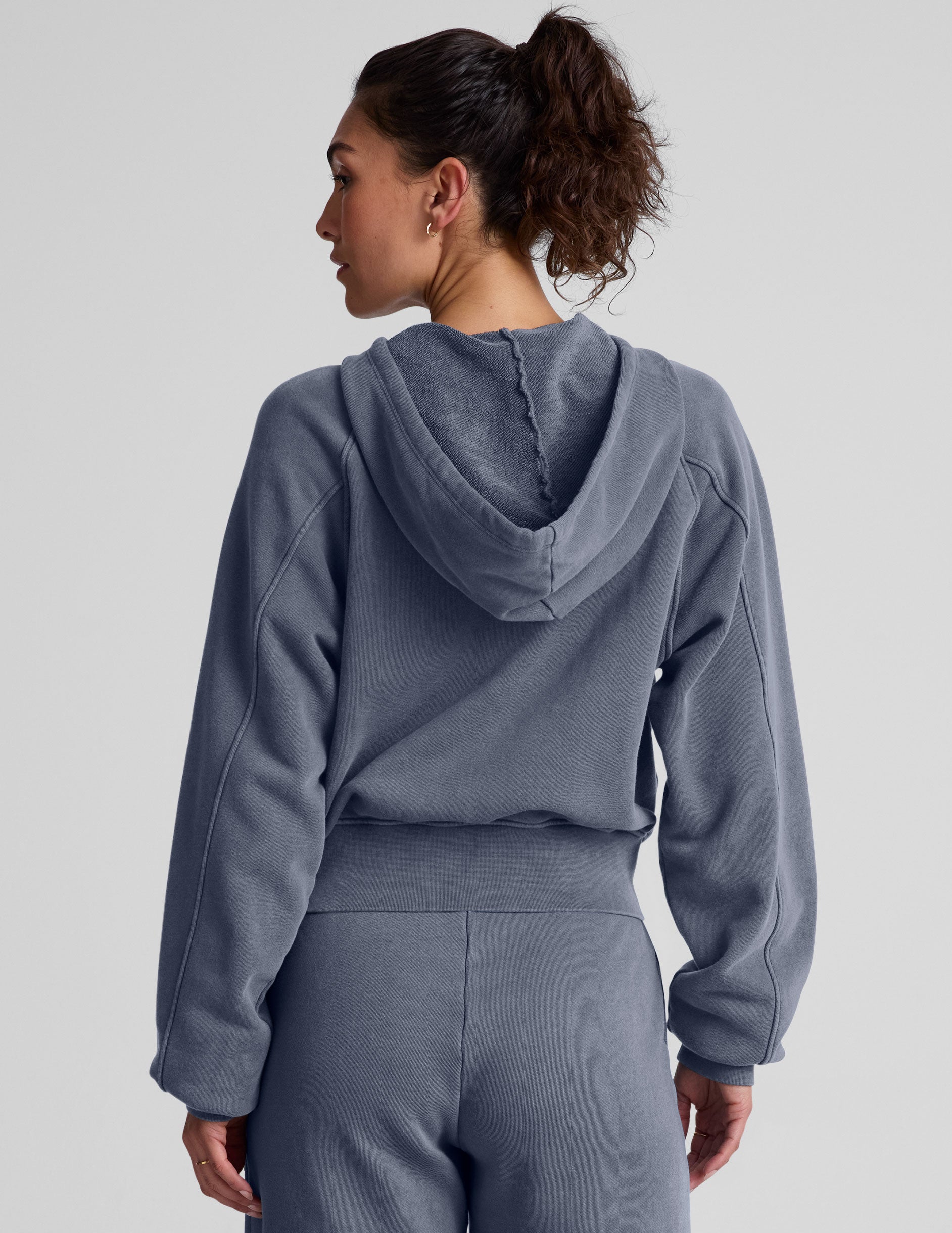blue zip-up jacket with pockets and a hoodie.