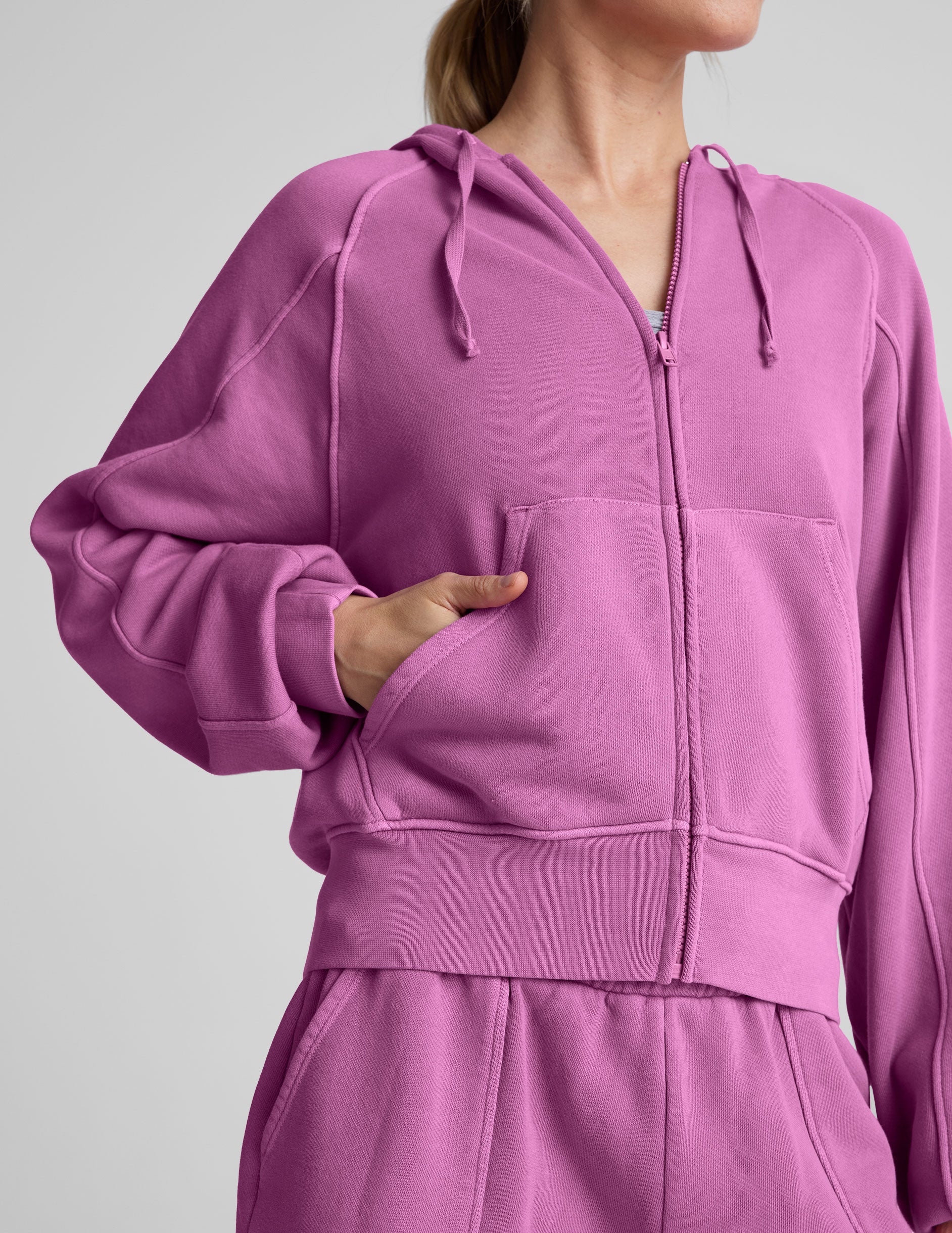 pink zip-up jacket with pockets and a hoodie.