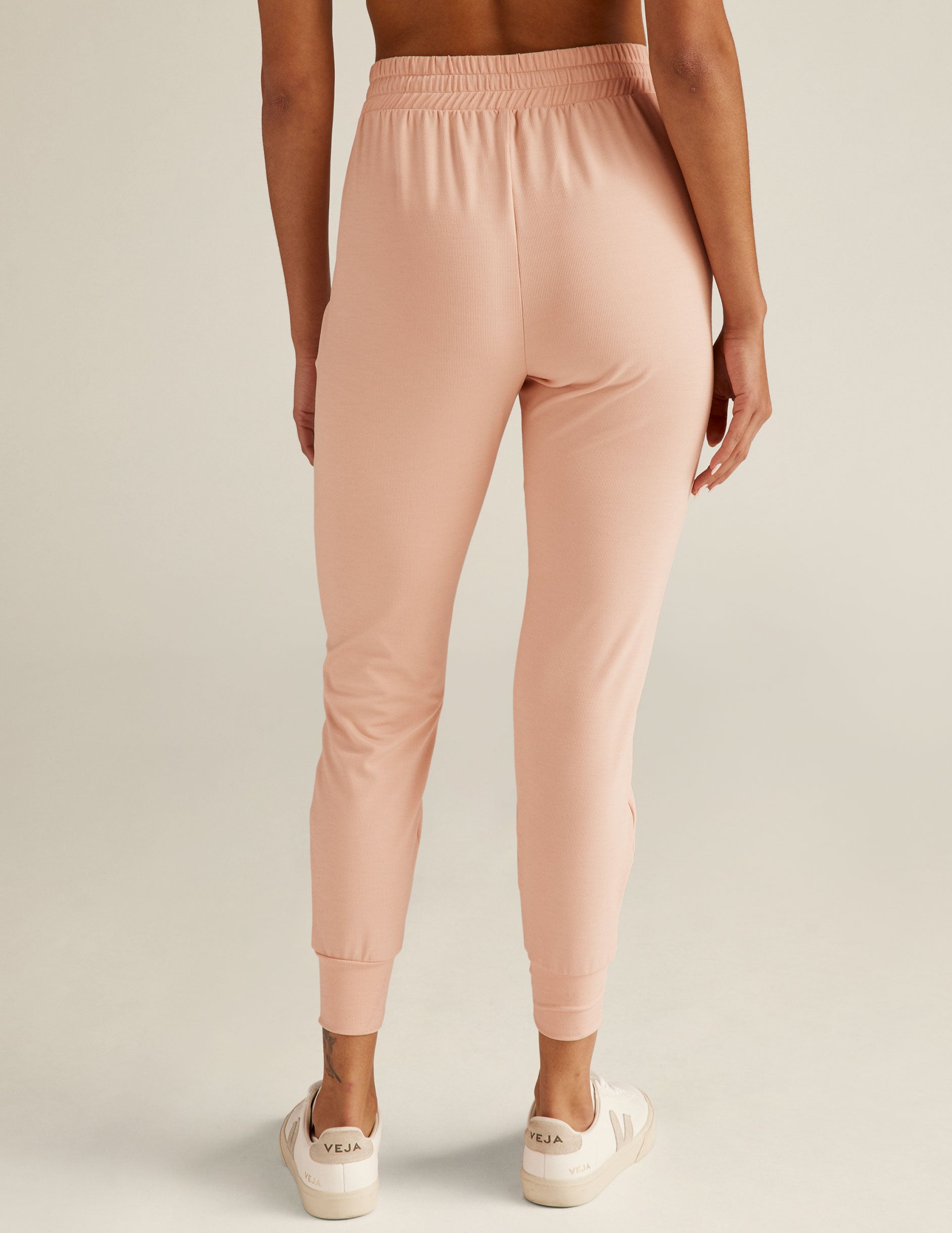 pink high-waisted midi joggers with pockets and a drawstring at waistband. 