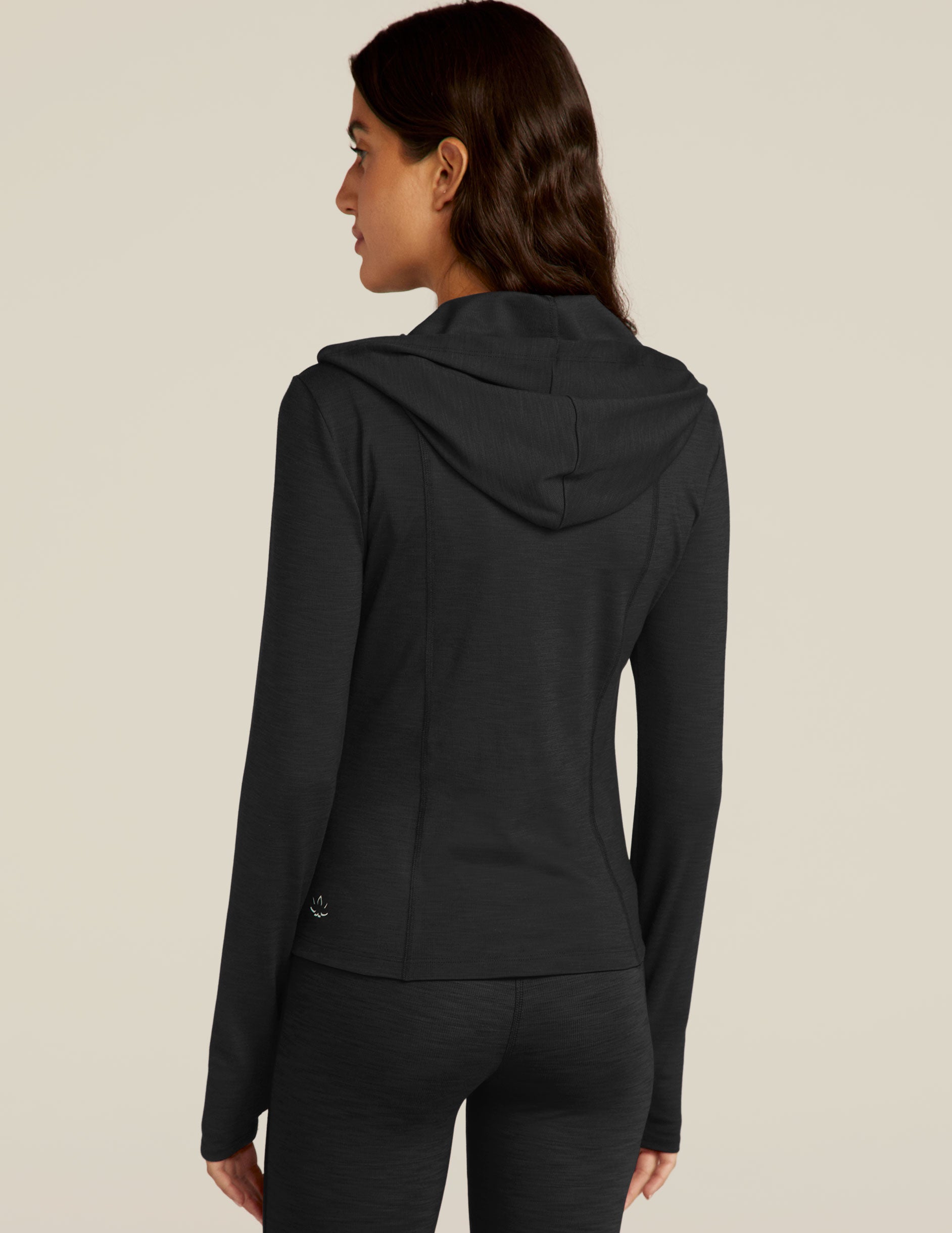 black zip-up jacket with a hoodie and thumb holes. 