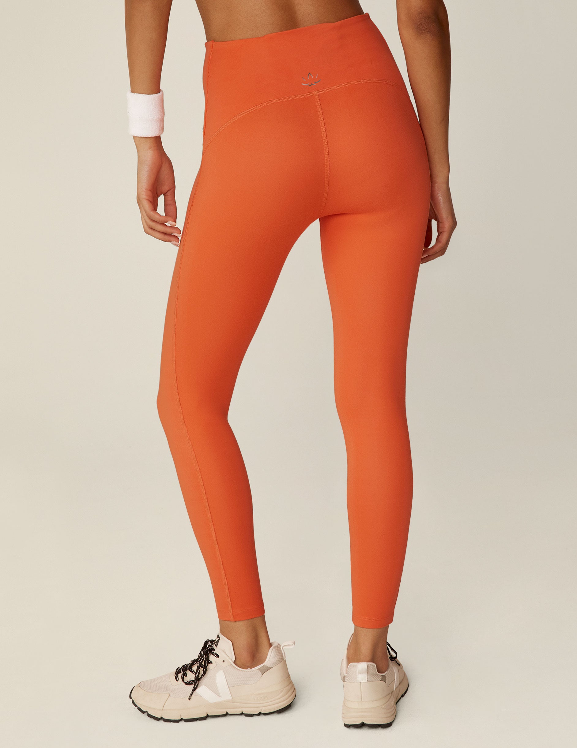 orange POWERBEYOND midi leggings. 
