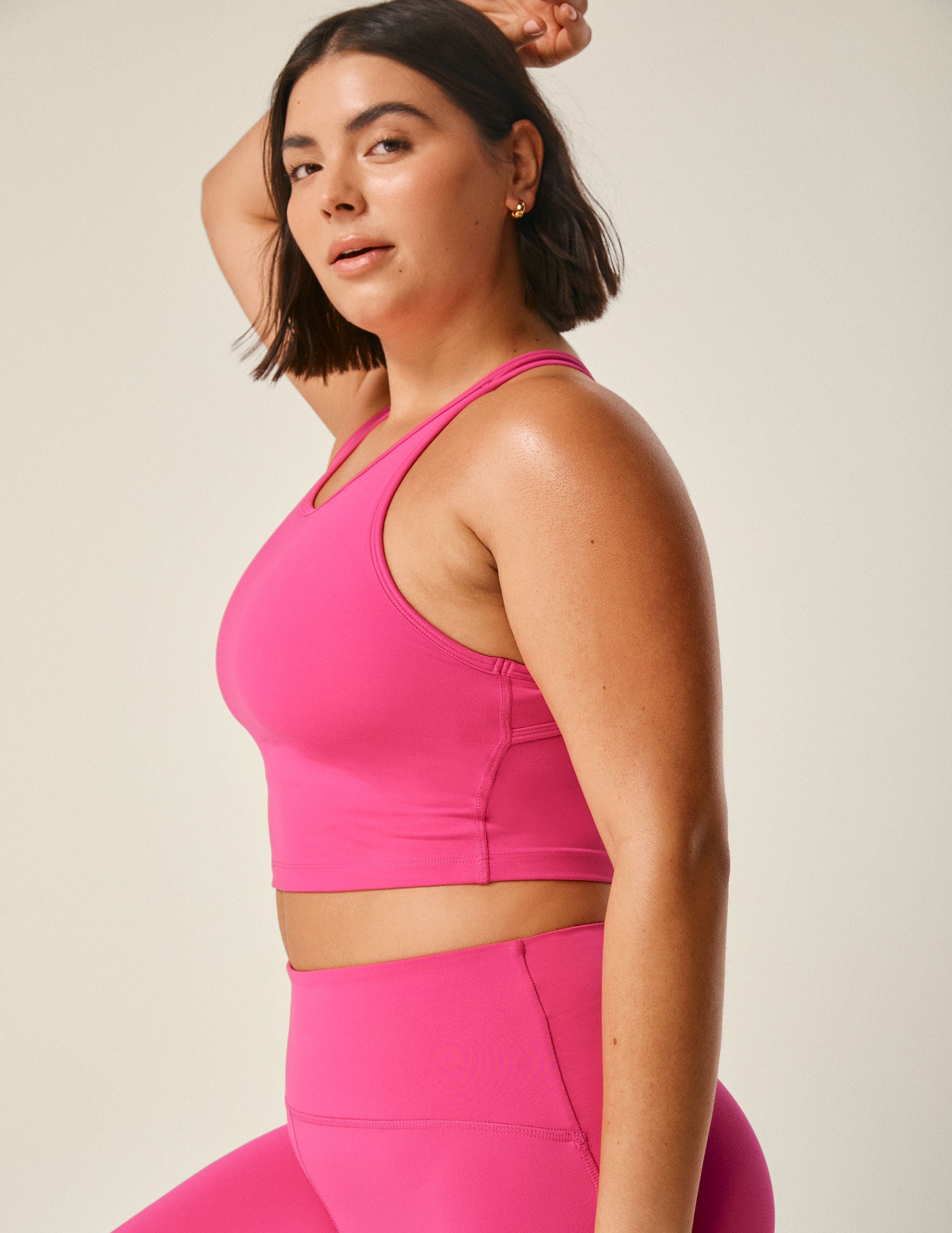 pink scoop neck racerback cropped tank with an open back detail held with bartacks.