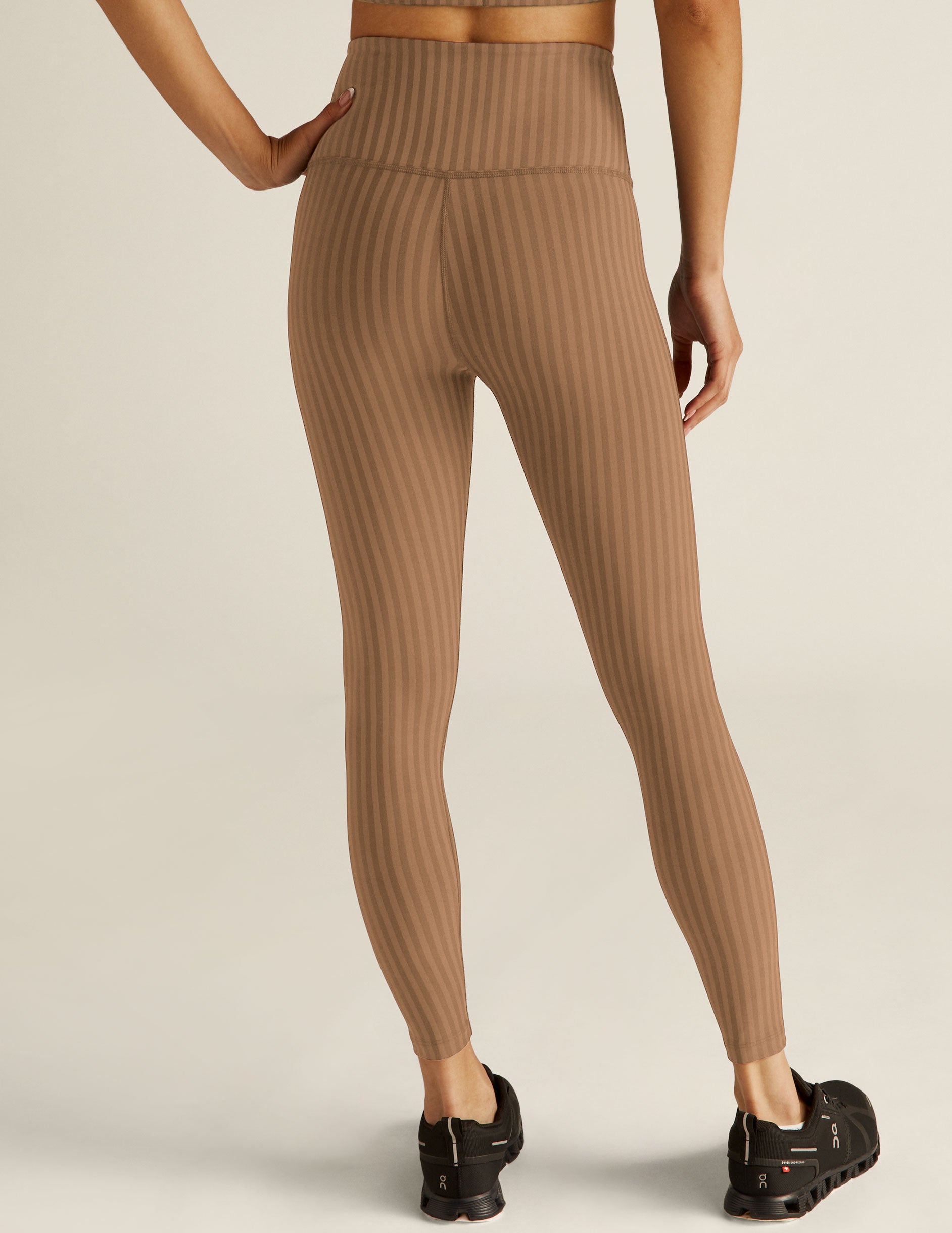 brown pin-striped printed high-waisted midi leggings.