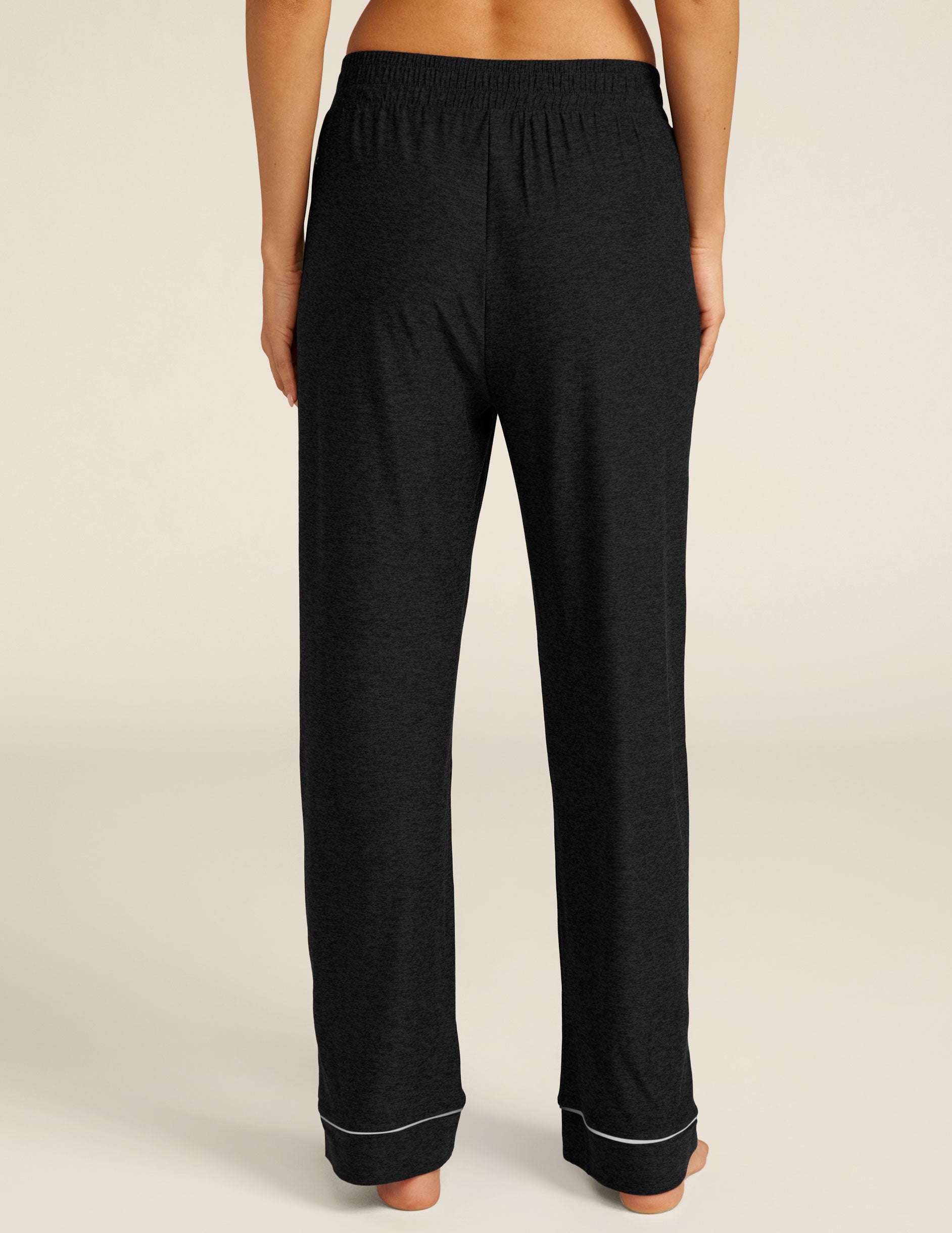 black sleep pants with white piping at ankles. 