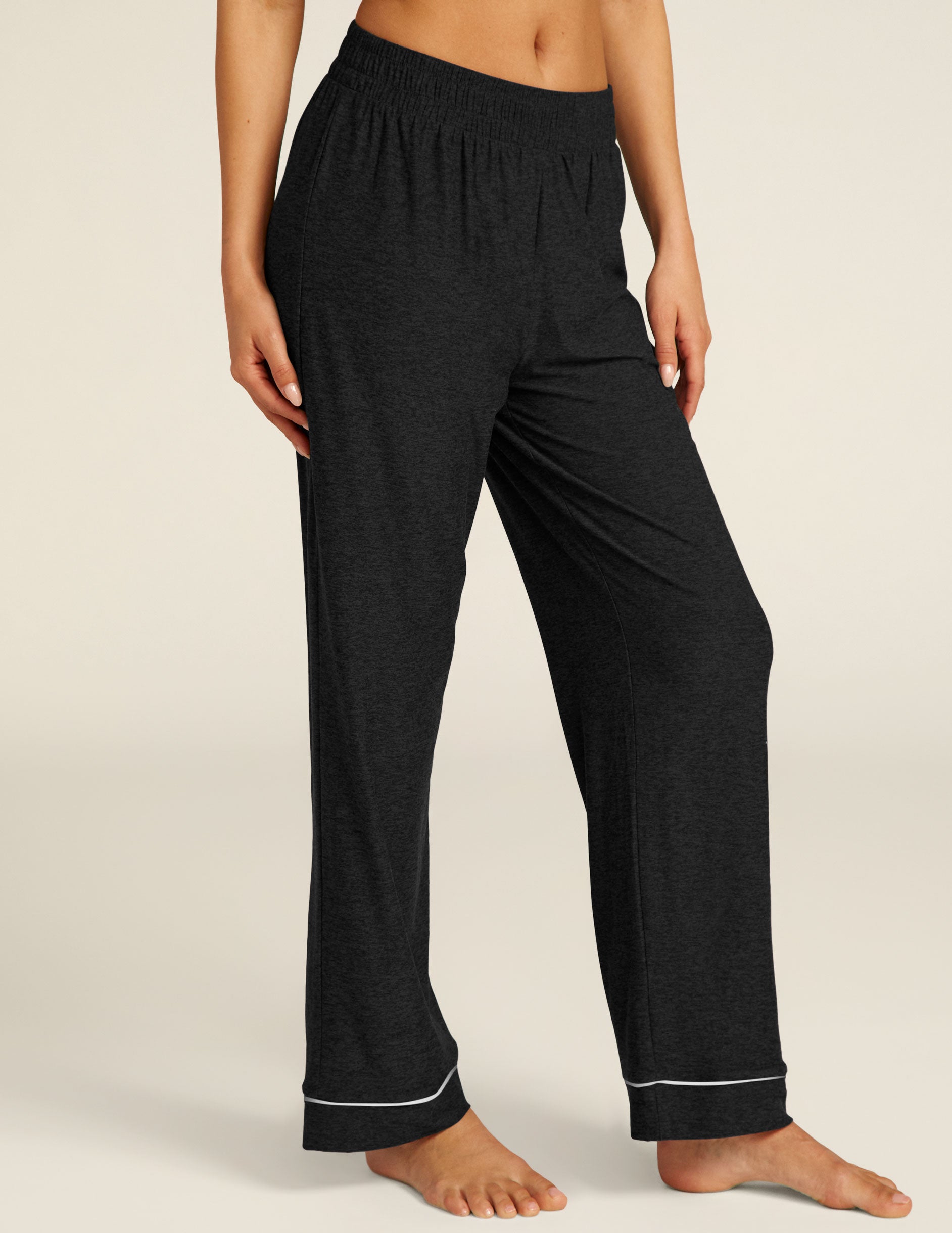 black sleep pants with white piping at ankles. 