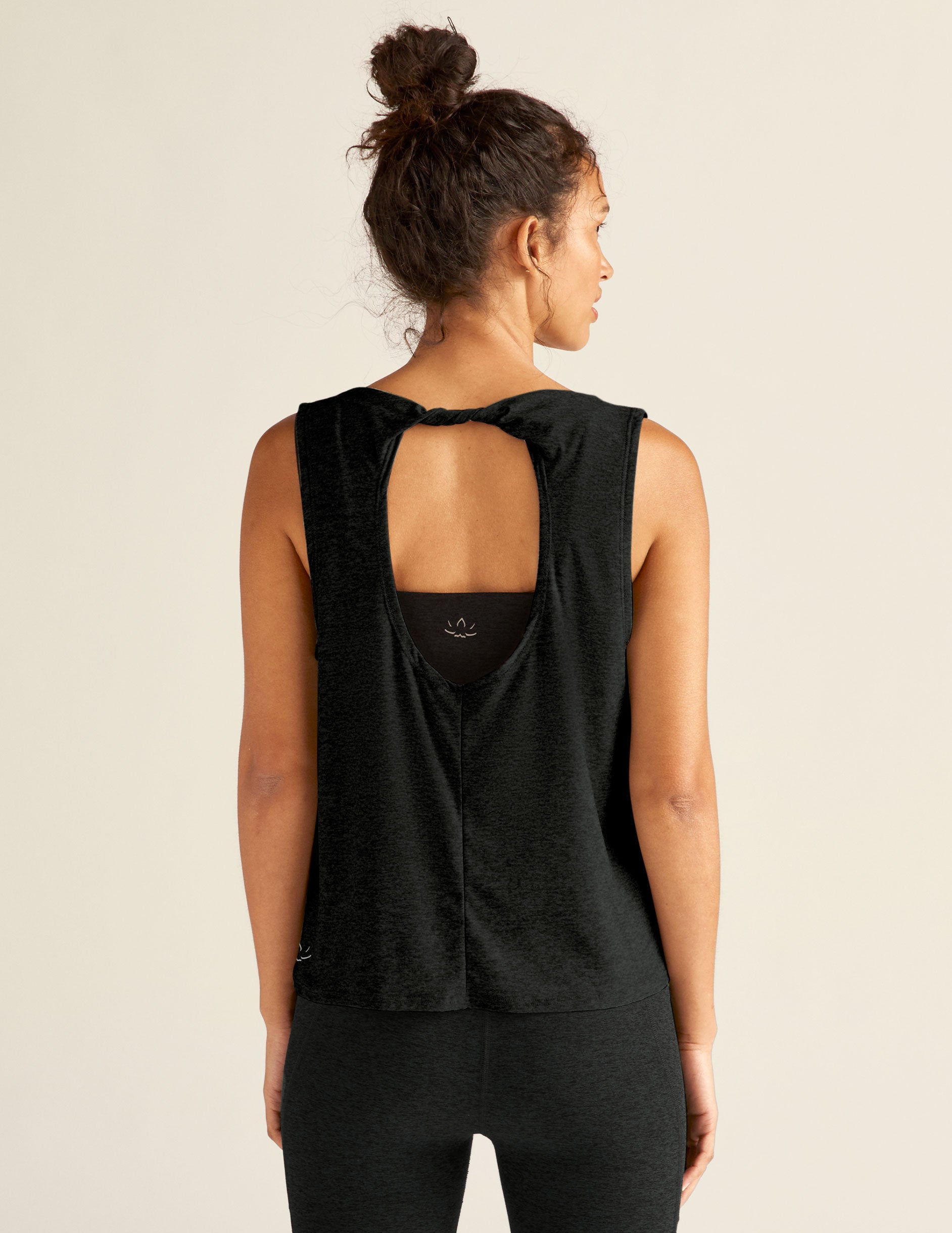 black tank top with open back detailing. 