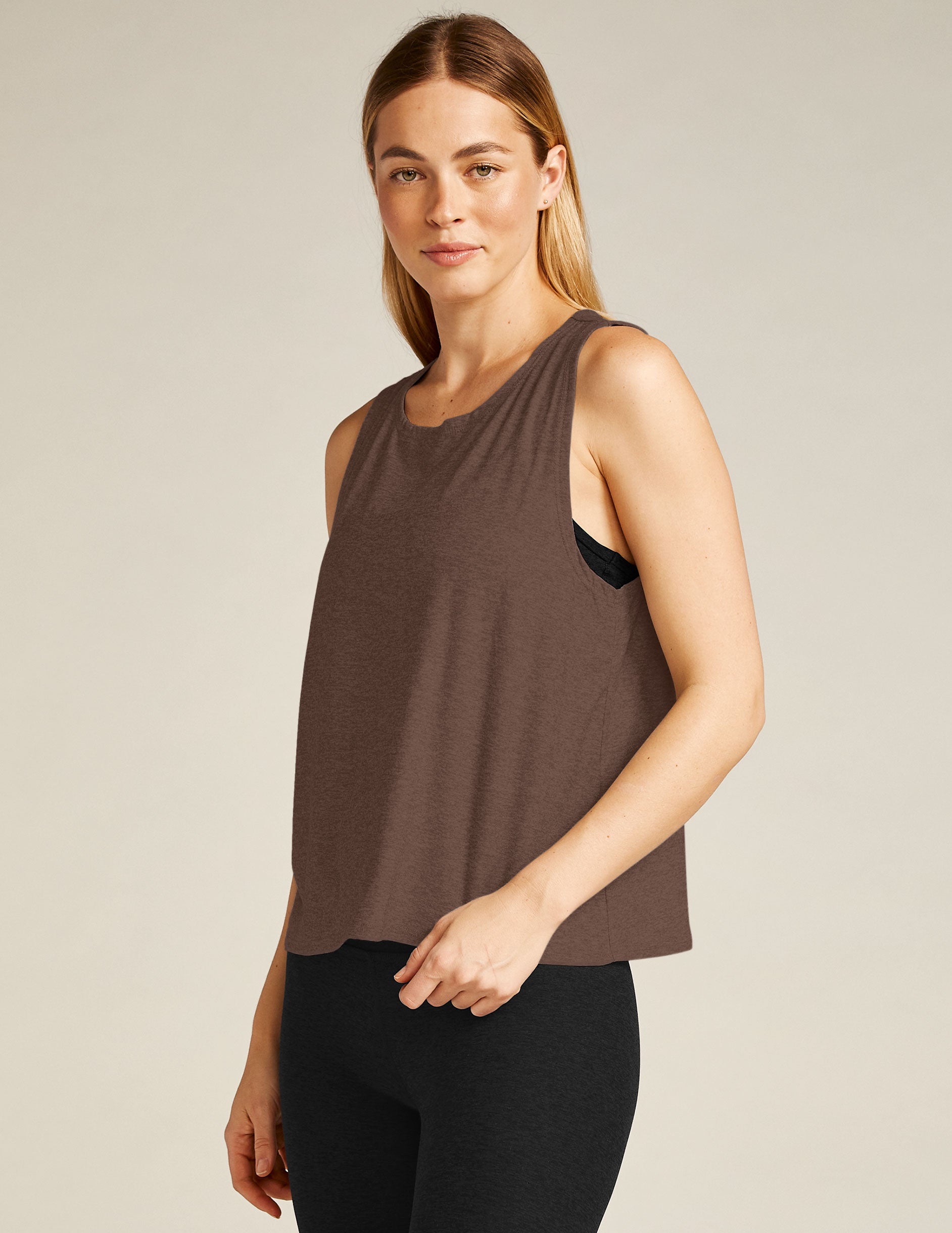 brown tank top with an open back, twisted detail. 