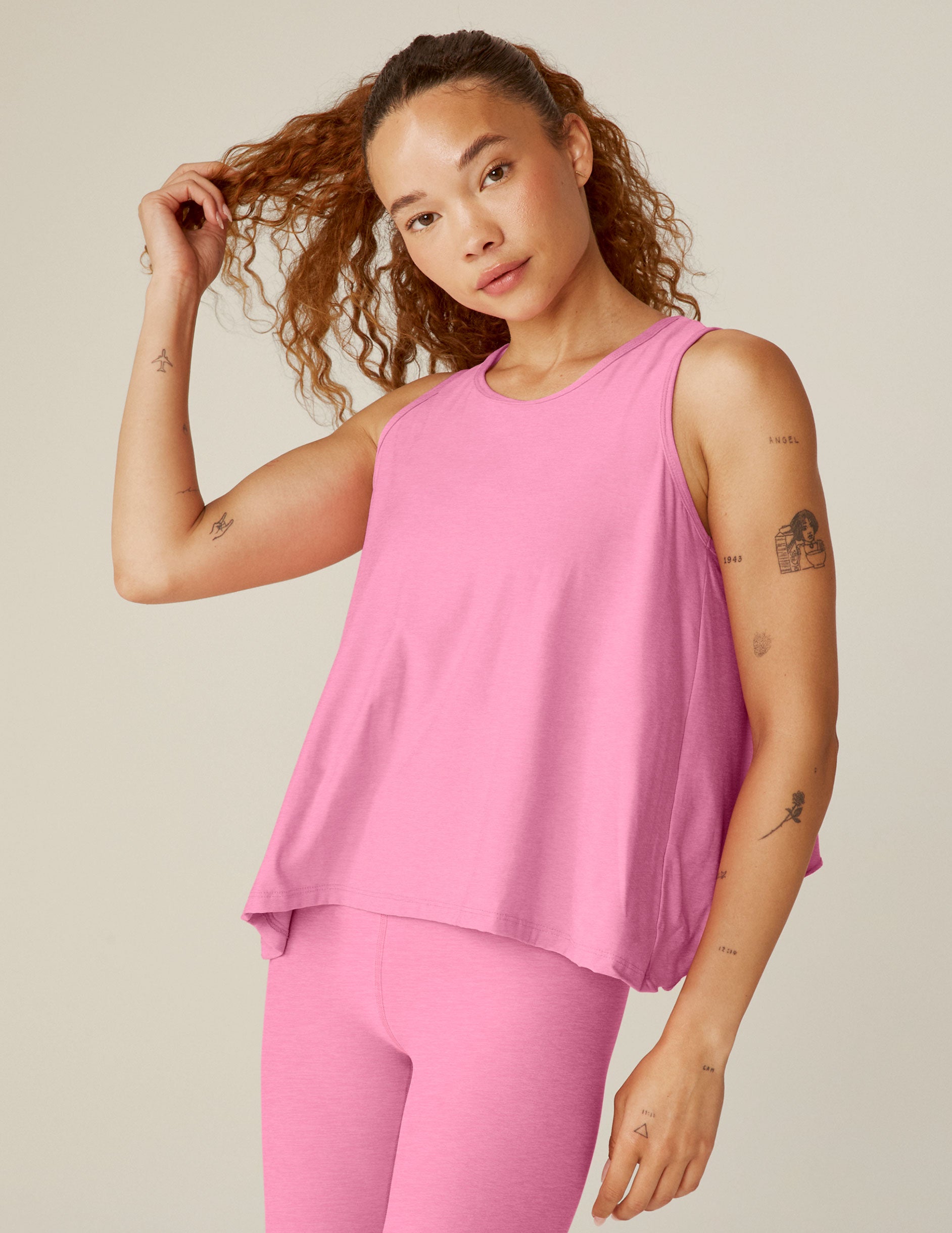 pink relaxed fit scooped neck tank top with a flounce open back.