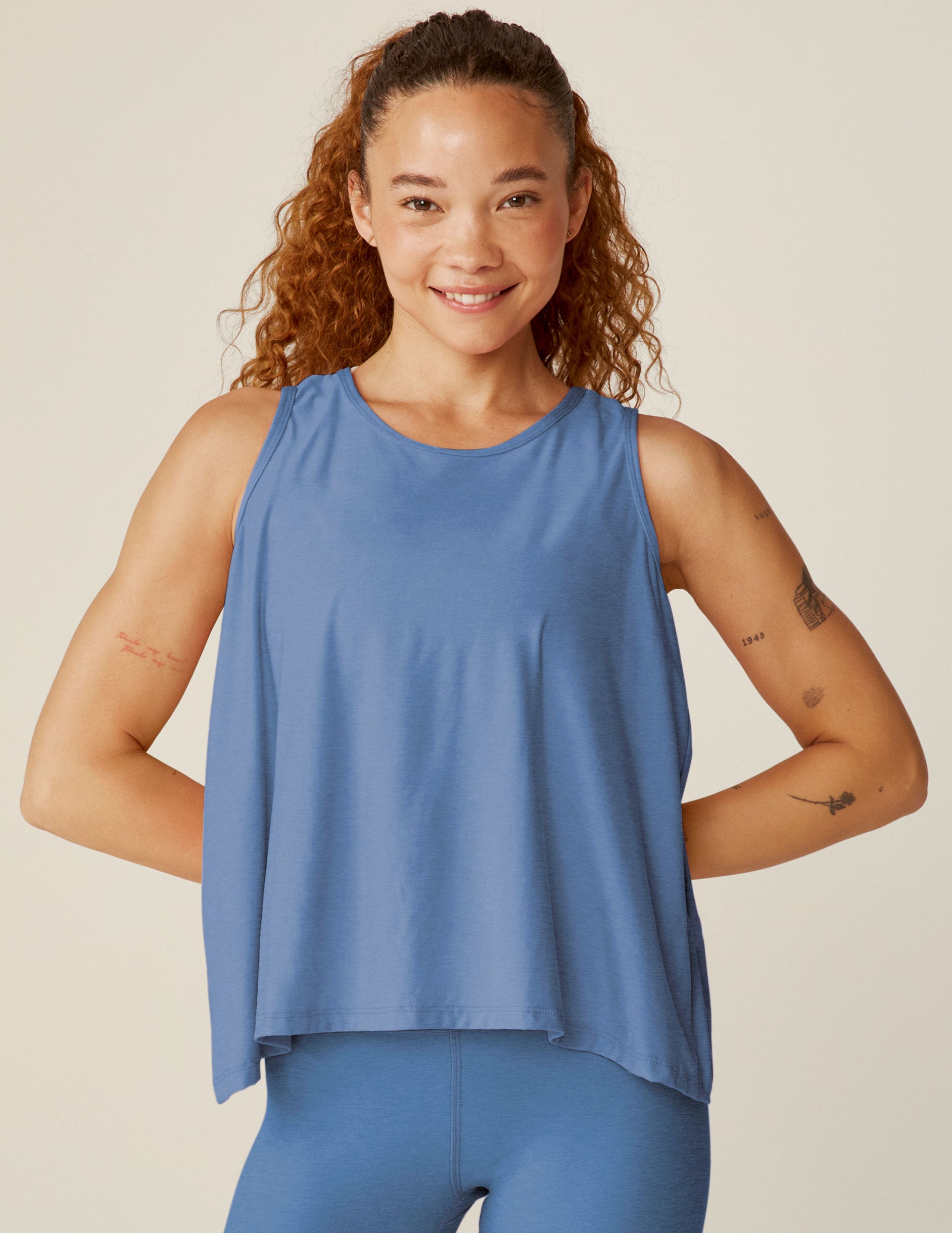 blue scooped neck tank top with a flounce open back design. 