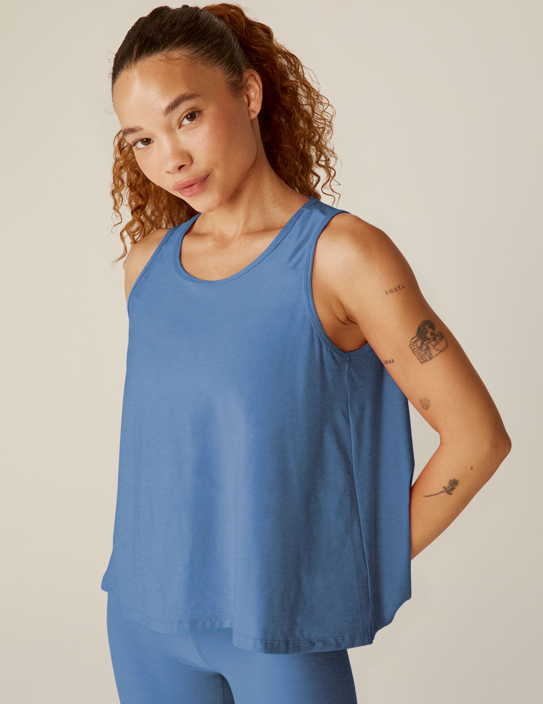 blue scooped neck tank top with a flounce open back design. 