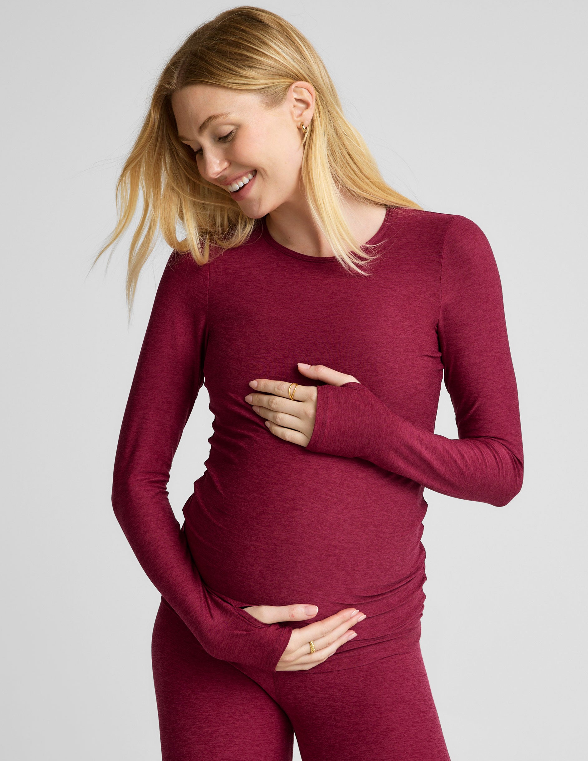 red scoop neck long sleeve maternity top with thumb holes.