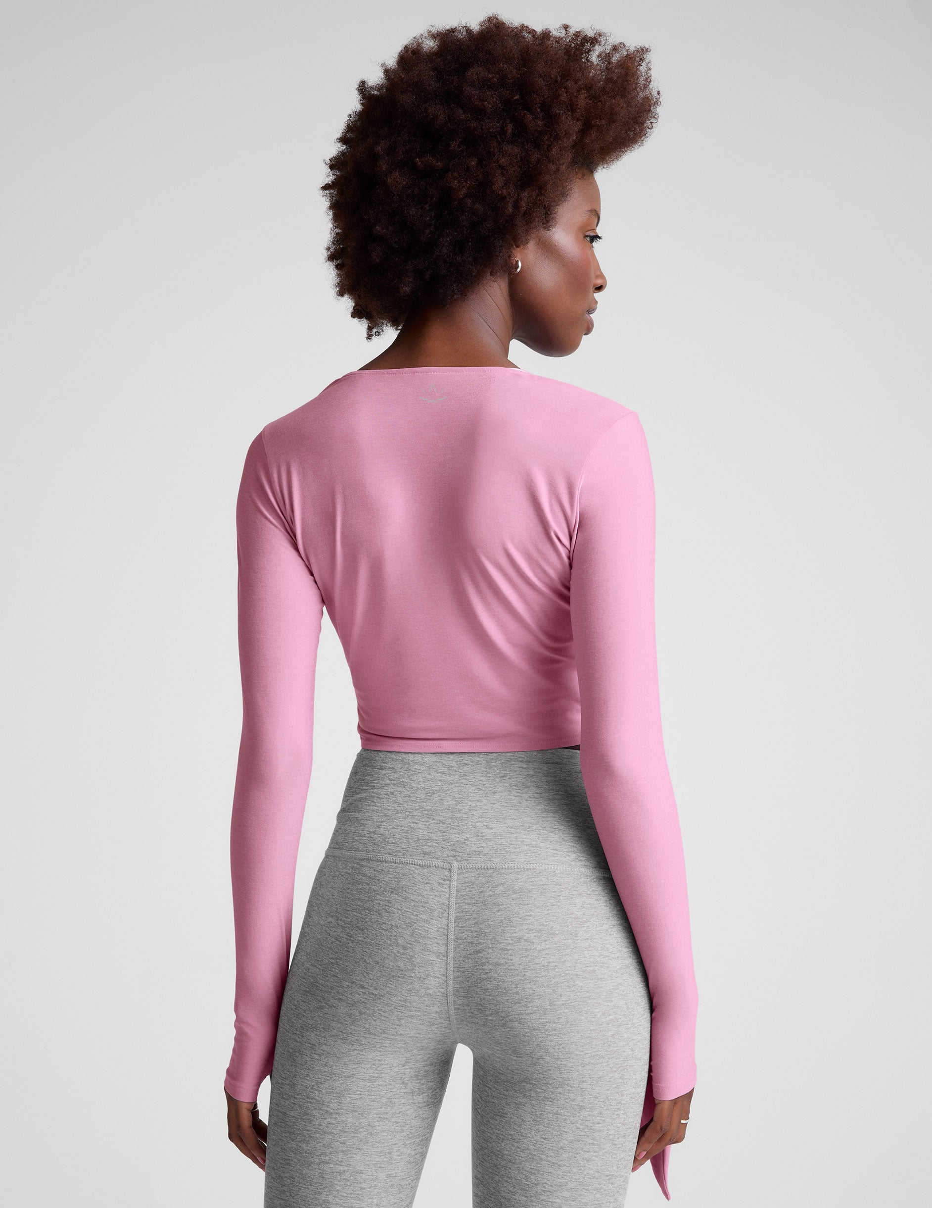 pink long sleeve wrap top with thumb holes.