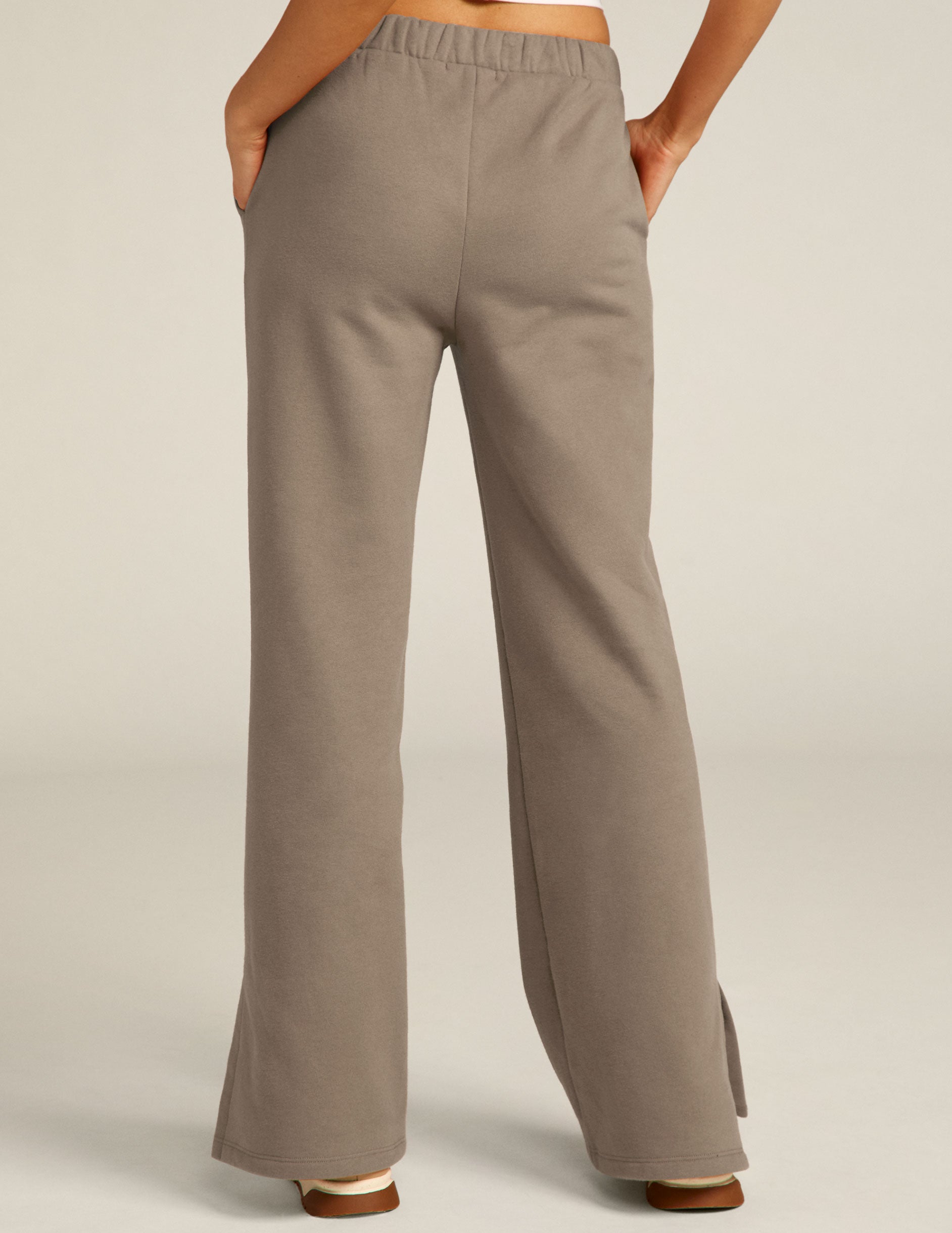 brown high rise pants with pockets and slit hem. 