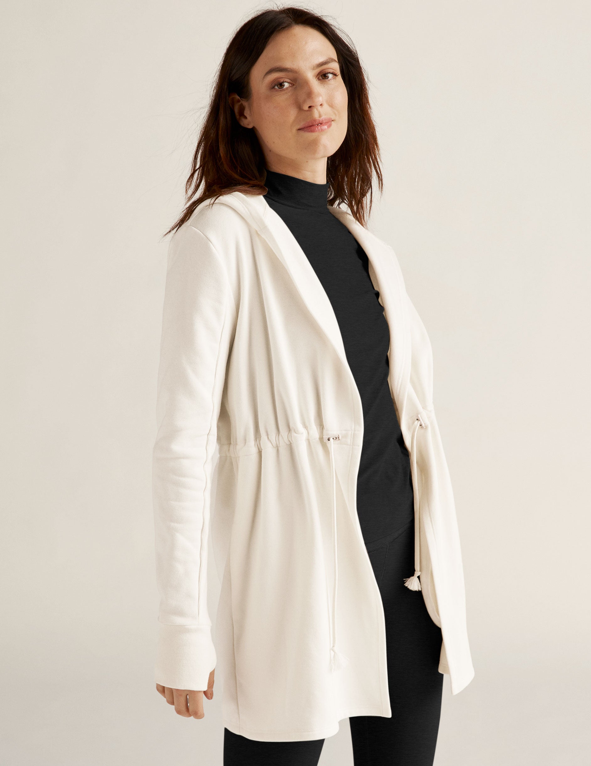 white jacket with drawstring at waist. 