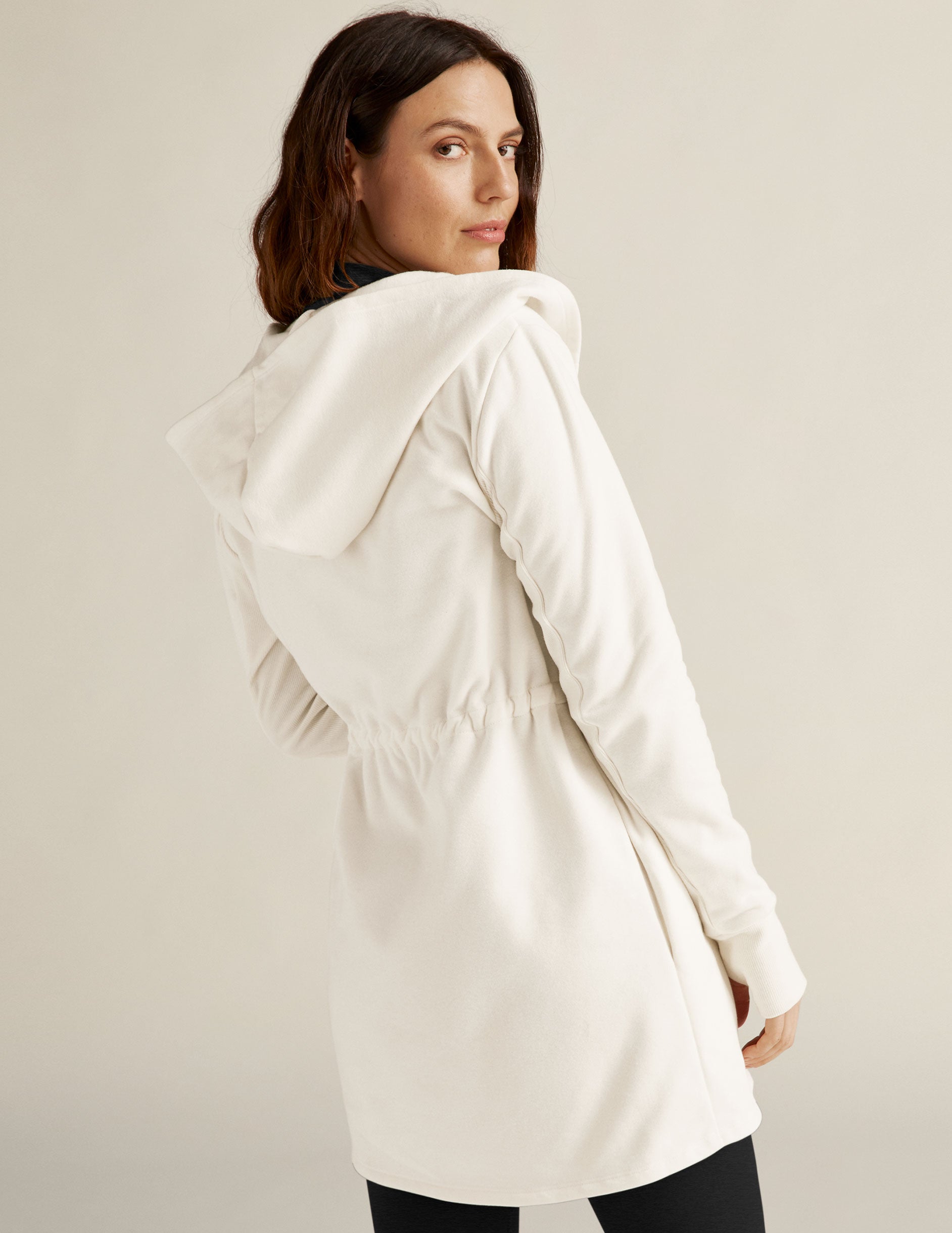 white jacket with drawstring at waist. 