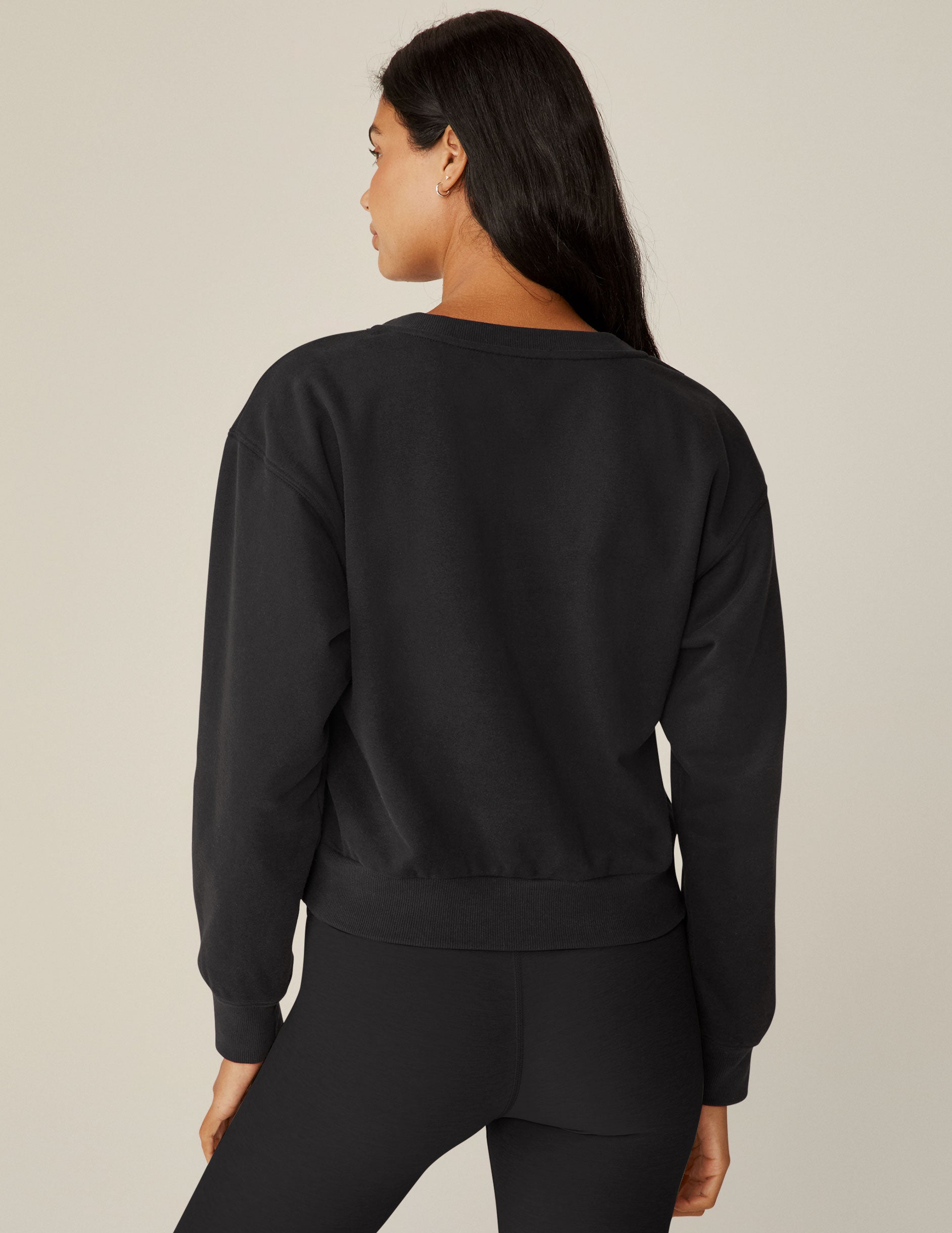 black loose-fitting classic length crew neck sweatshirt.
