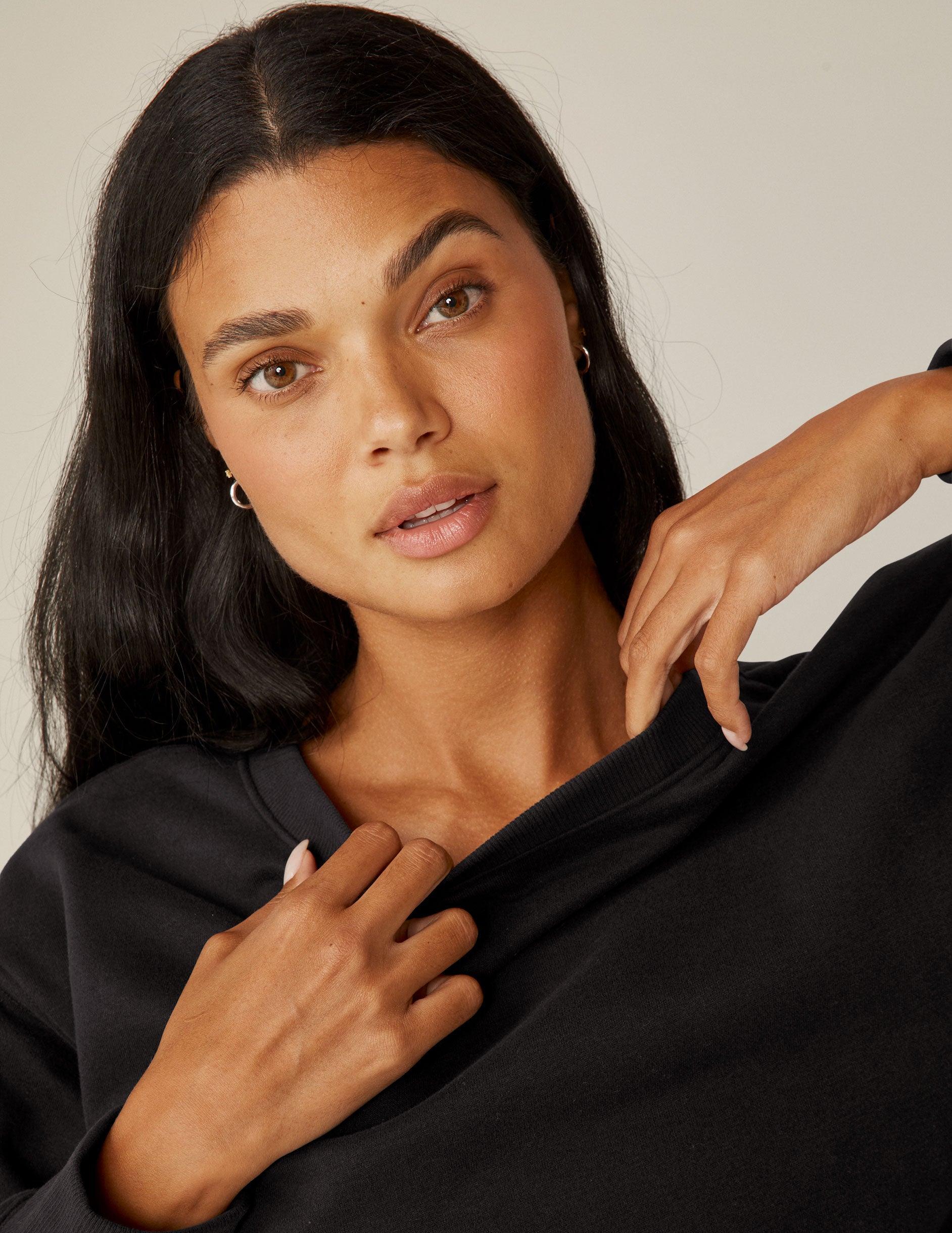 black loose-fitting classic length crew neck sweatshirt.