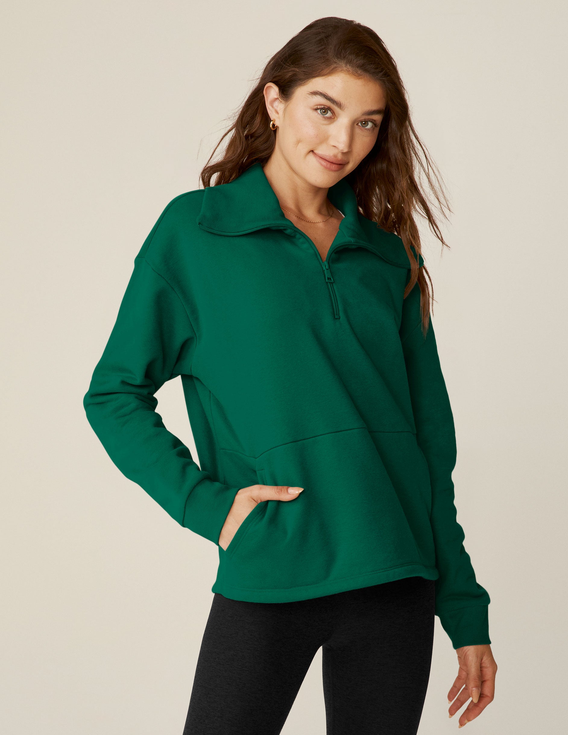 green quarter zip pullover jacket with a kangaroo pouch. 