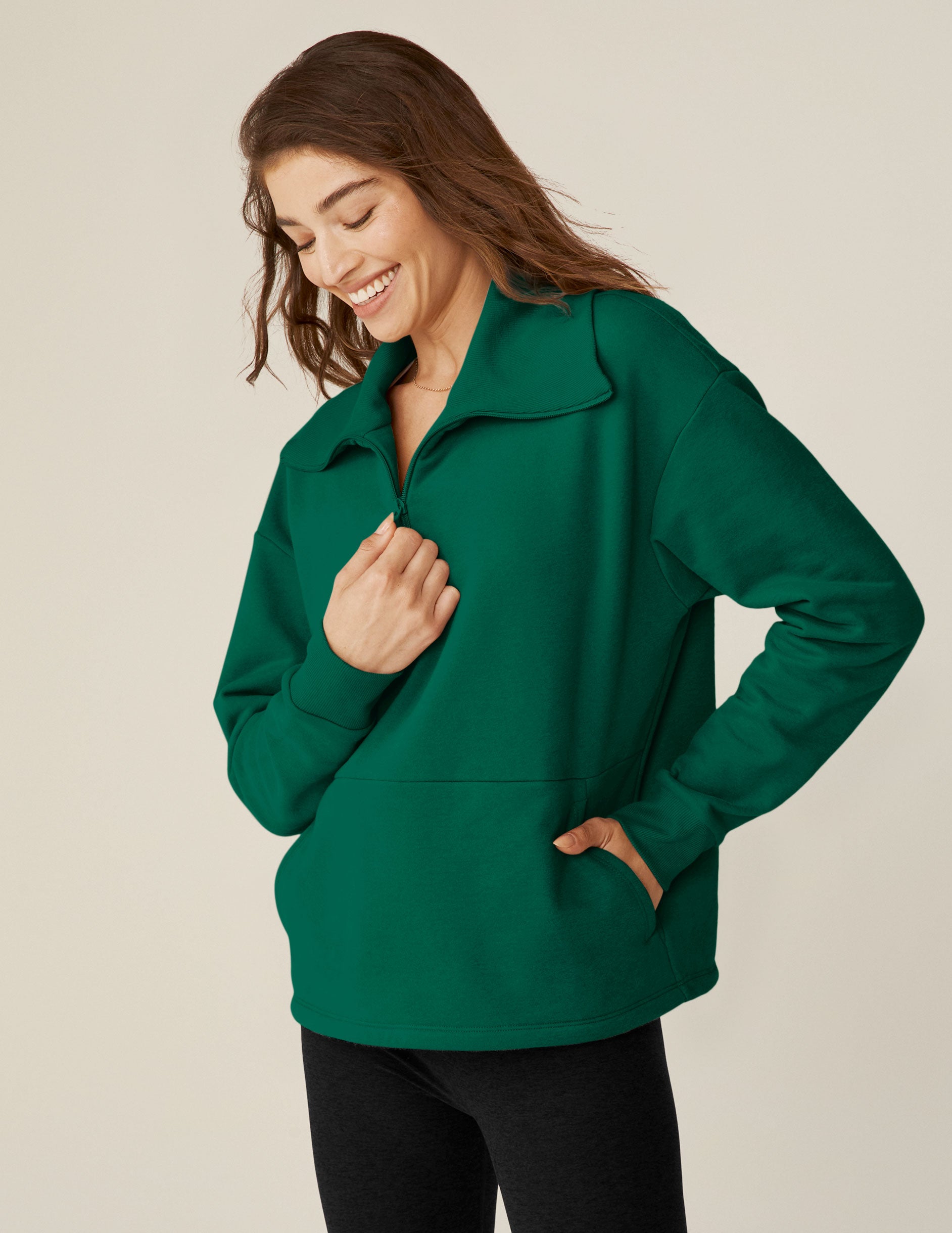 green quarter zip pullover jacket with a kangaroo pouch.