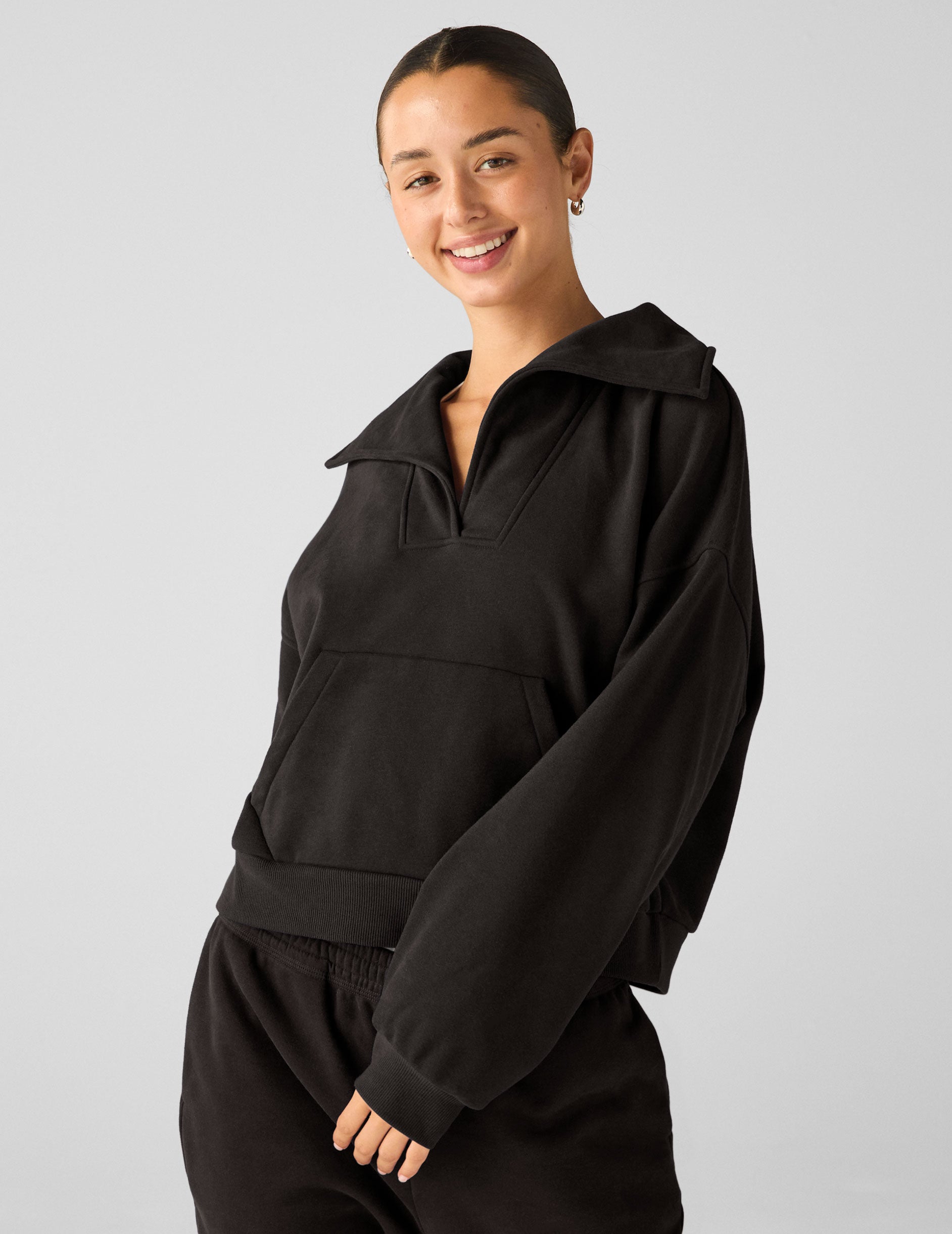 black pullover with a collar and kangaroo pocket.