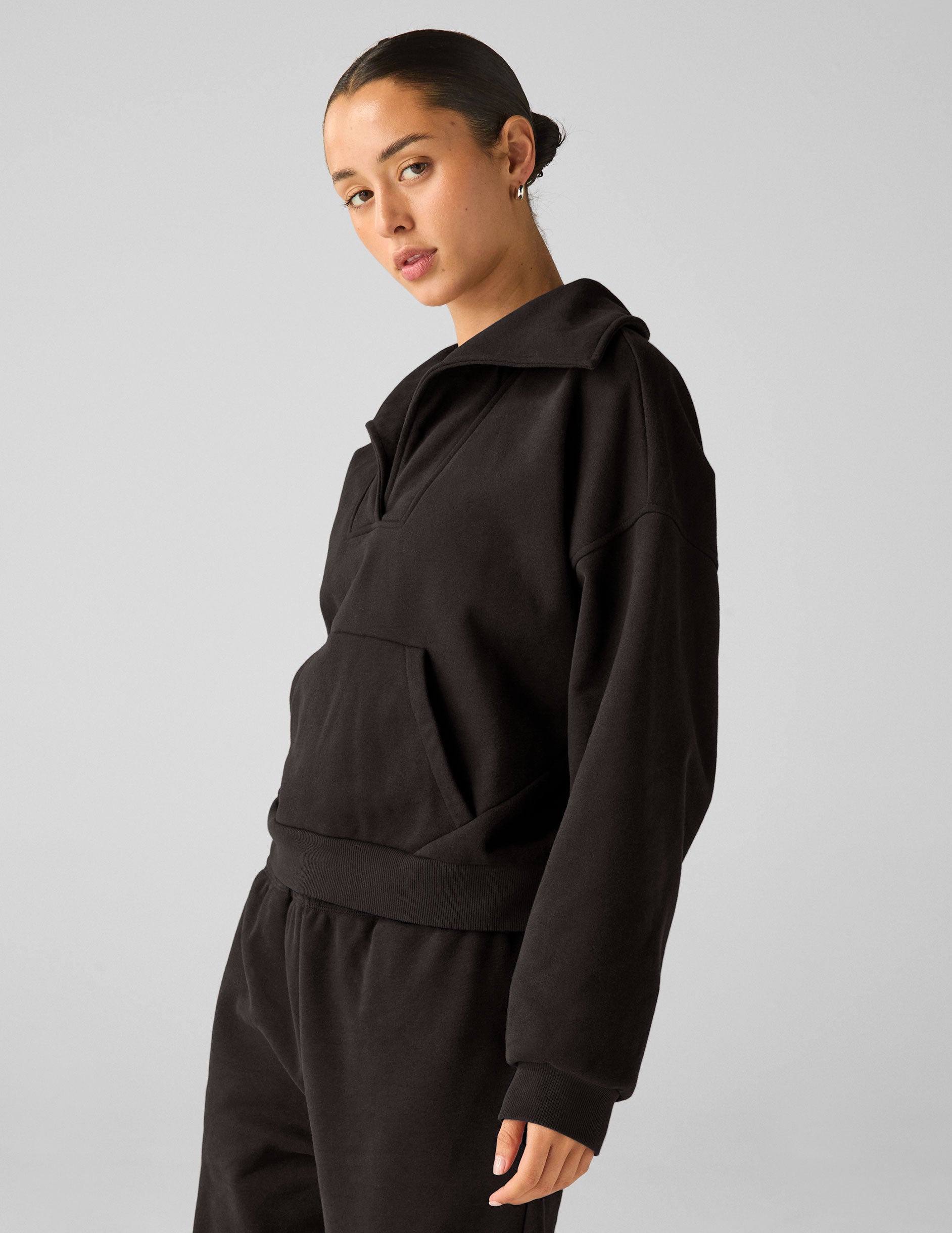 black pullover with a collar and kangaroo pocket.