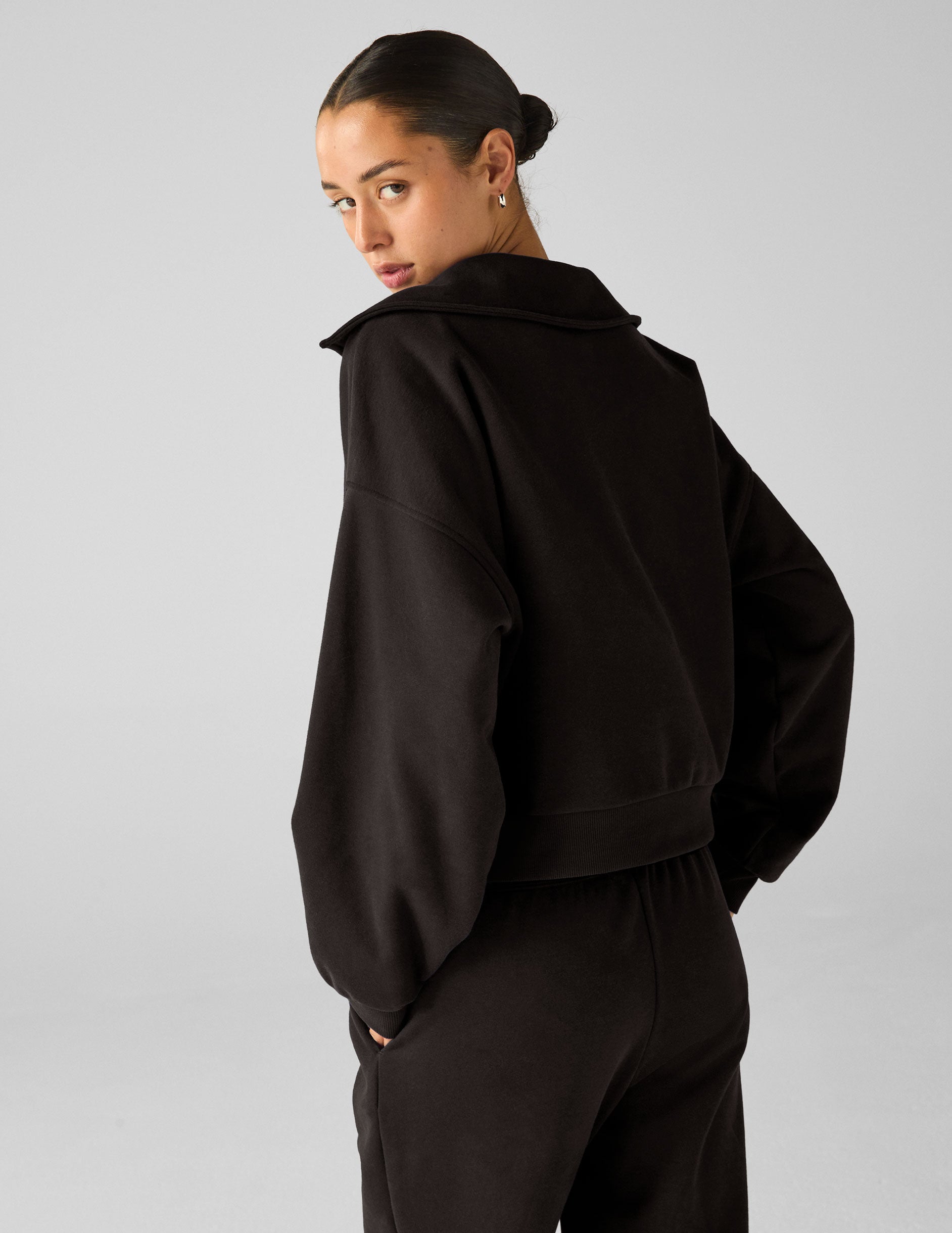 black pullover with a collar and kangaroo pocket.