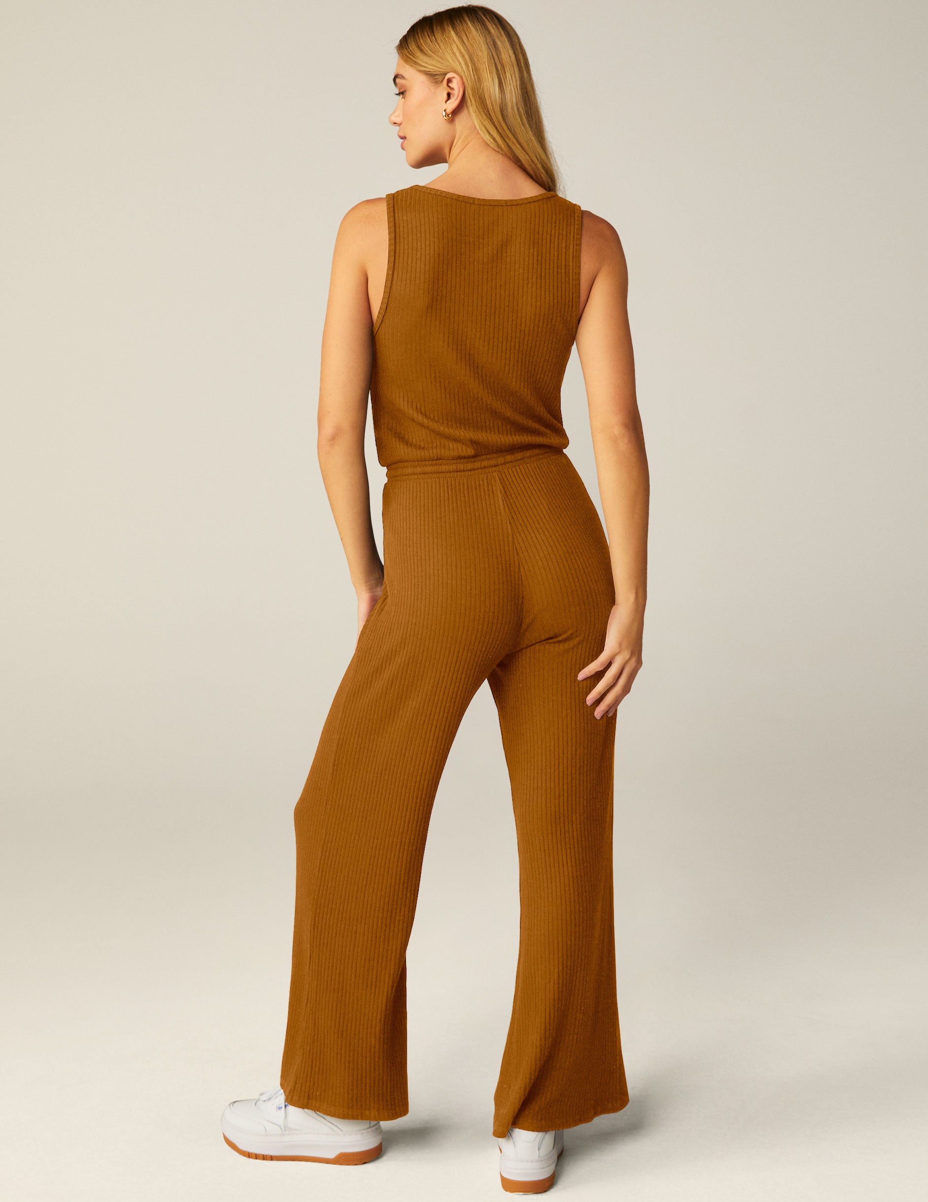 brown ribbed jumpsuit with a drawstring at waist. 