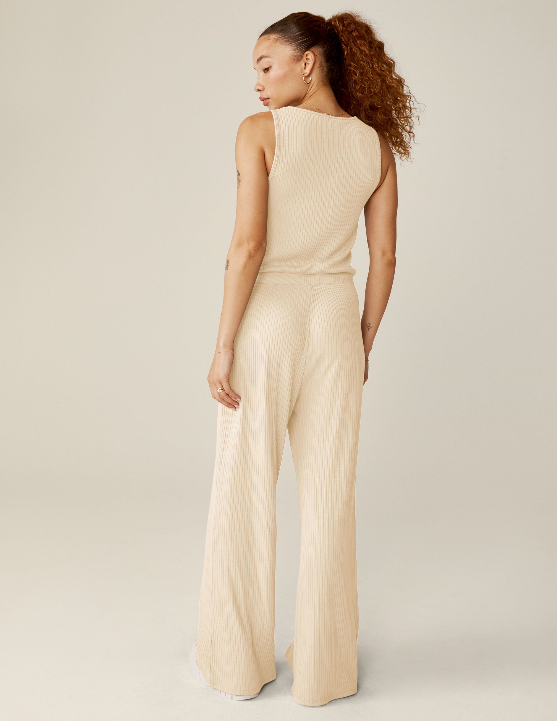 white v-neck ribbed jumpsuit with a drawstring at waistband. 