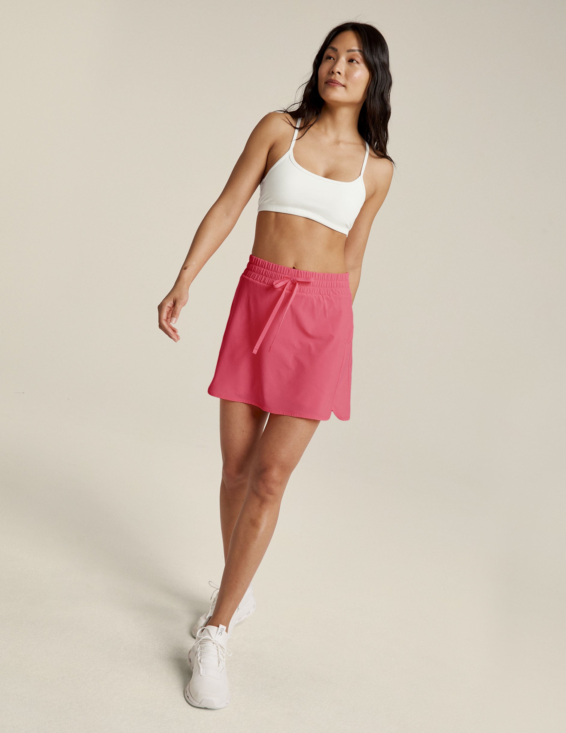 pink mini skirt with a drawstring at the waistband. 