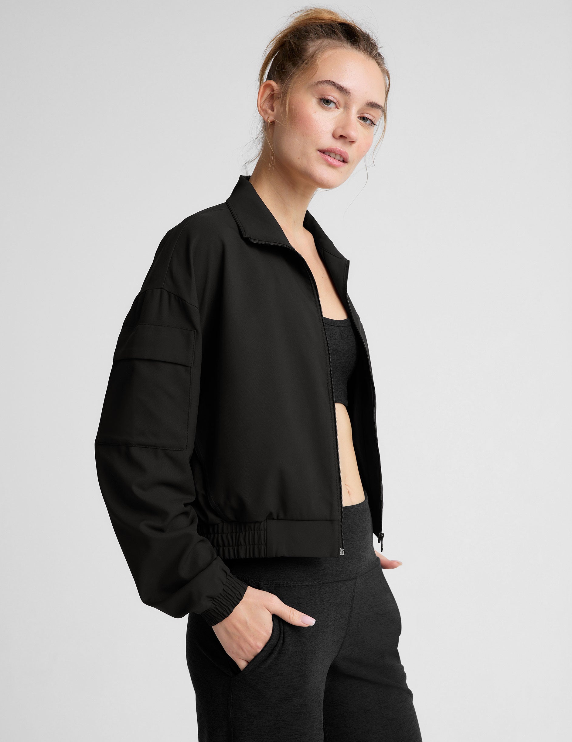 black zip-up jetstretch woven jacket with a collar.